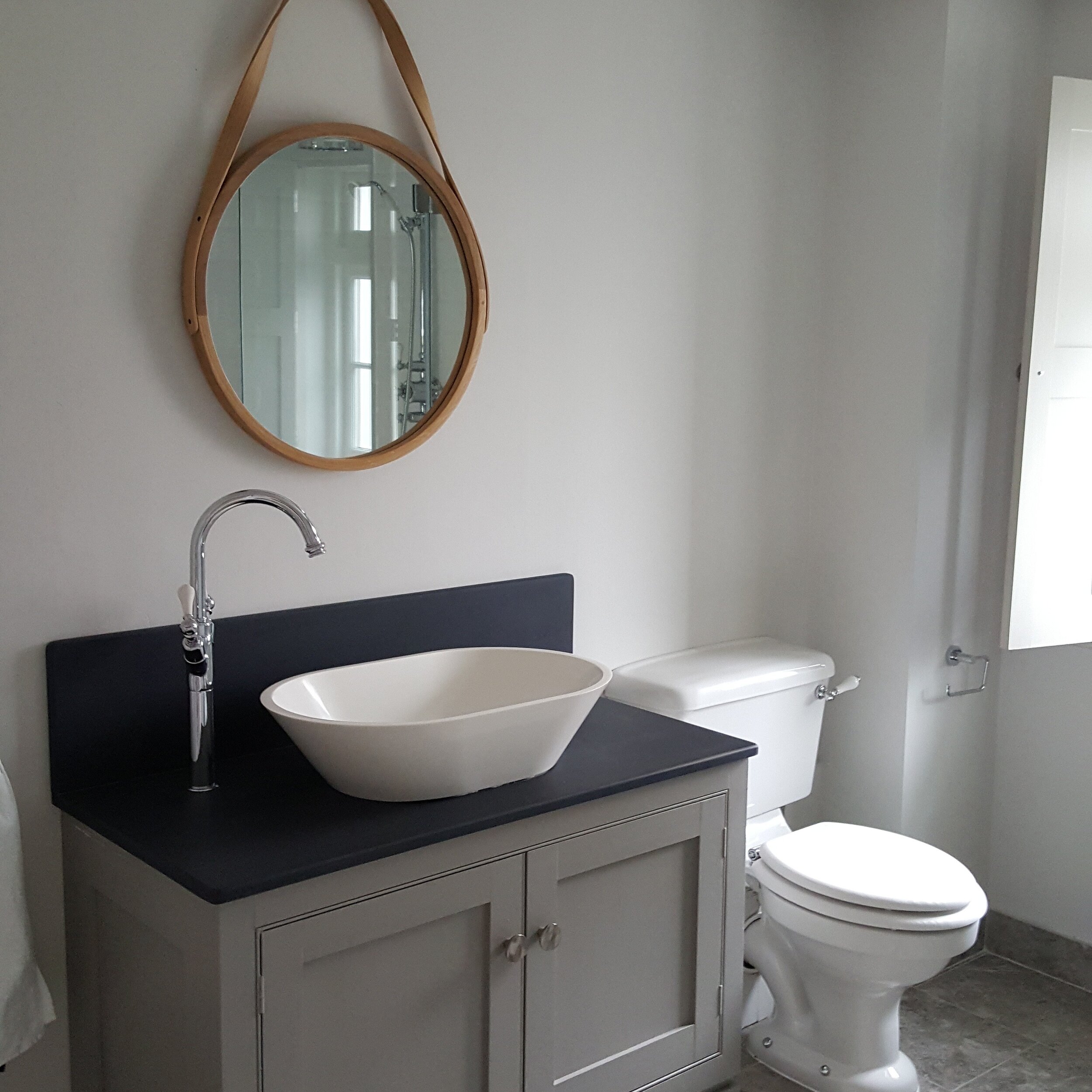 Wooden unit by locally based Castle House Joinery slate tops clay plastered walls Earthborn clay paint and Tom Raffields toxin and chemical free mirror