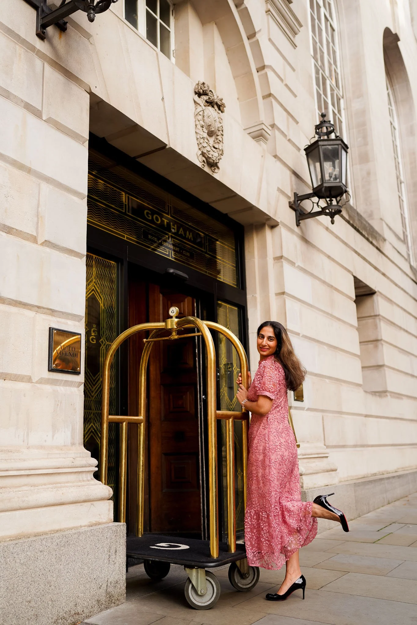Professional headshot of businesswoman & Pharmacist LawPharm aka Thorrun Govind with city skyline of Manchester and Hotel Gotham in the background