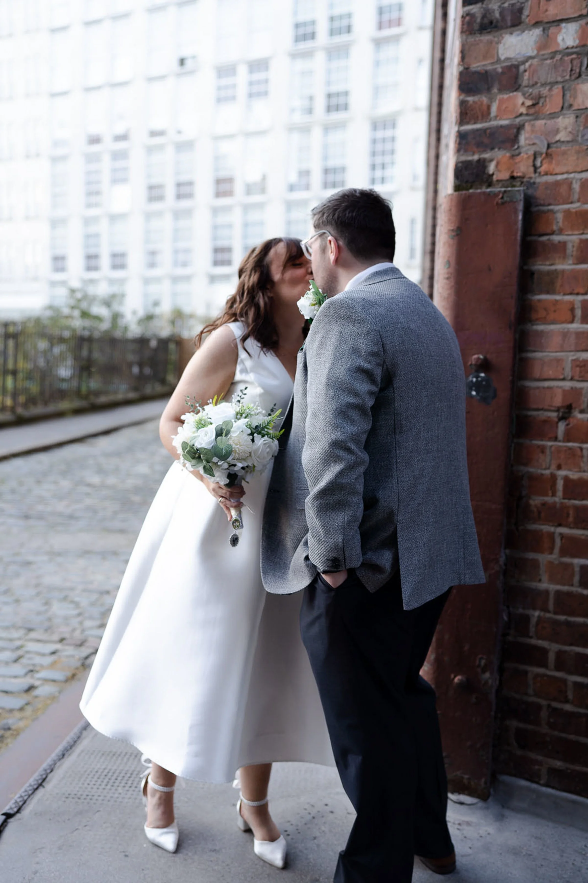 A bride and groom share a kiss at their first look on their wedding day