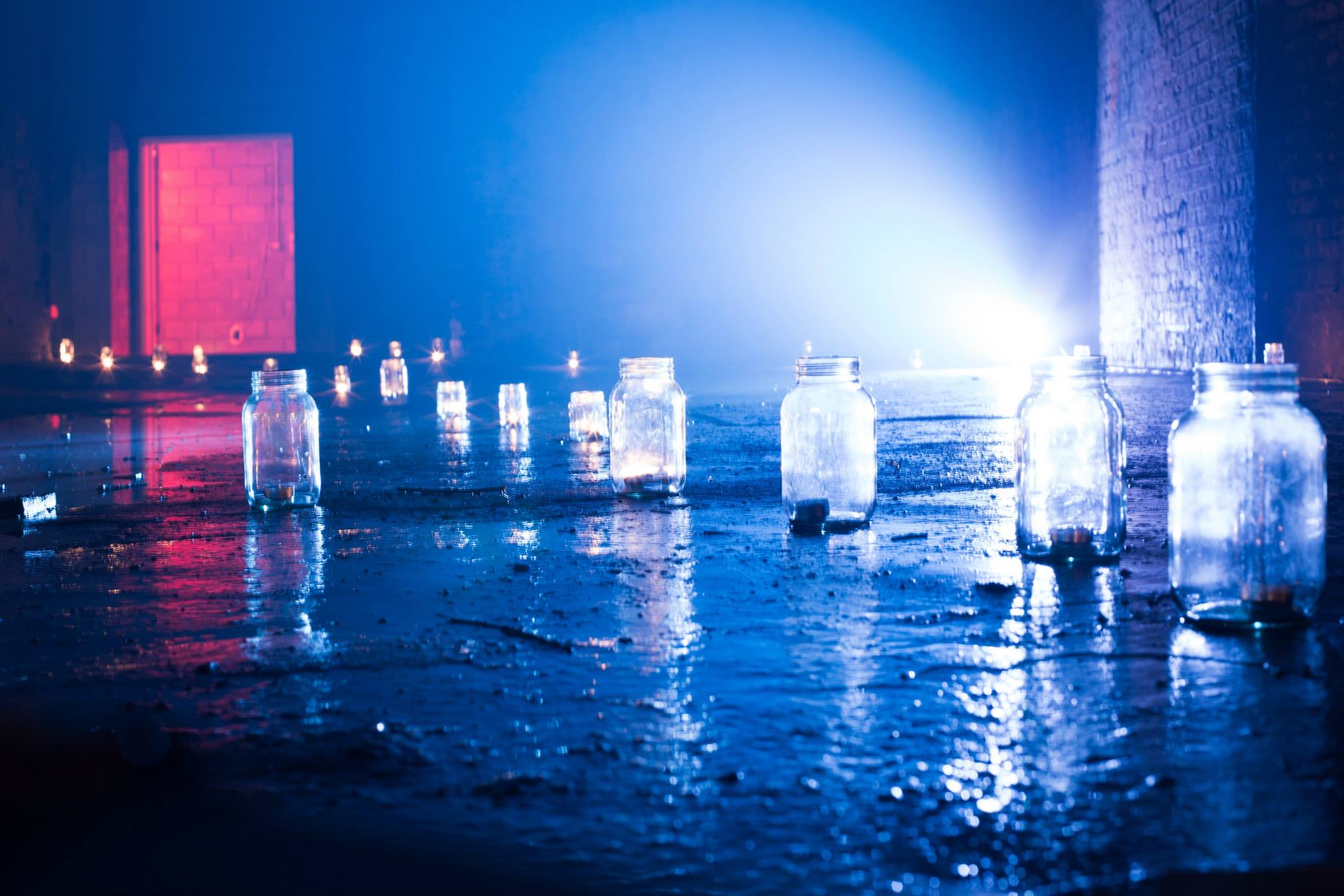 'He had set out candles as he had done the night before, and they glowed in jam jars around the floor...'