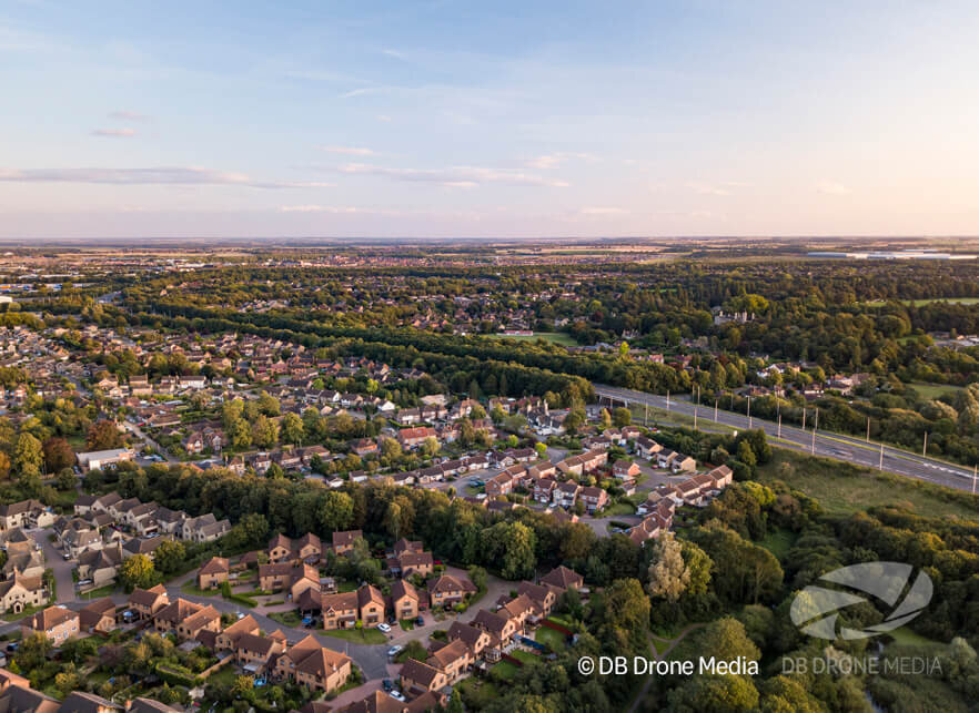 Cars travelling into city past Suburbs - Aerial Photography