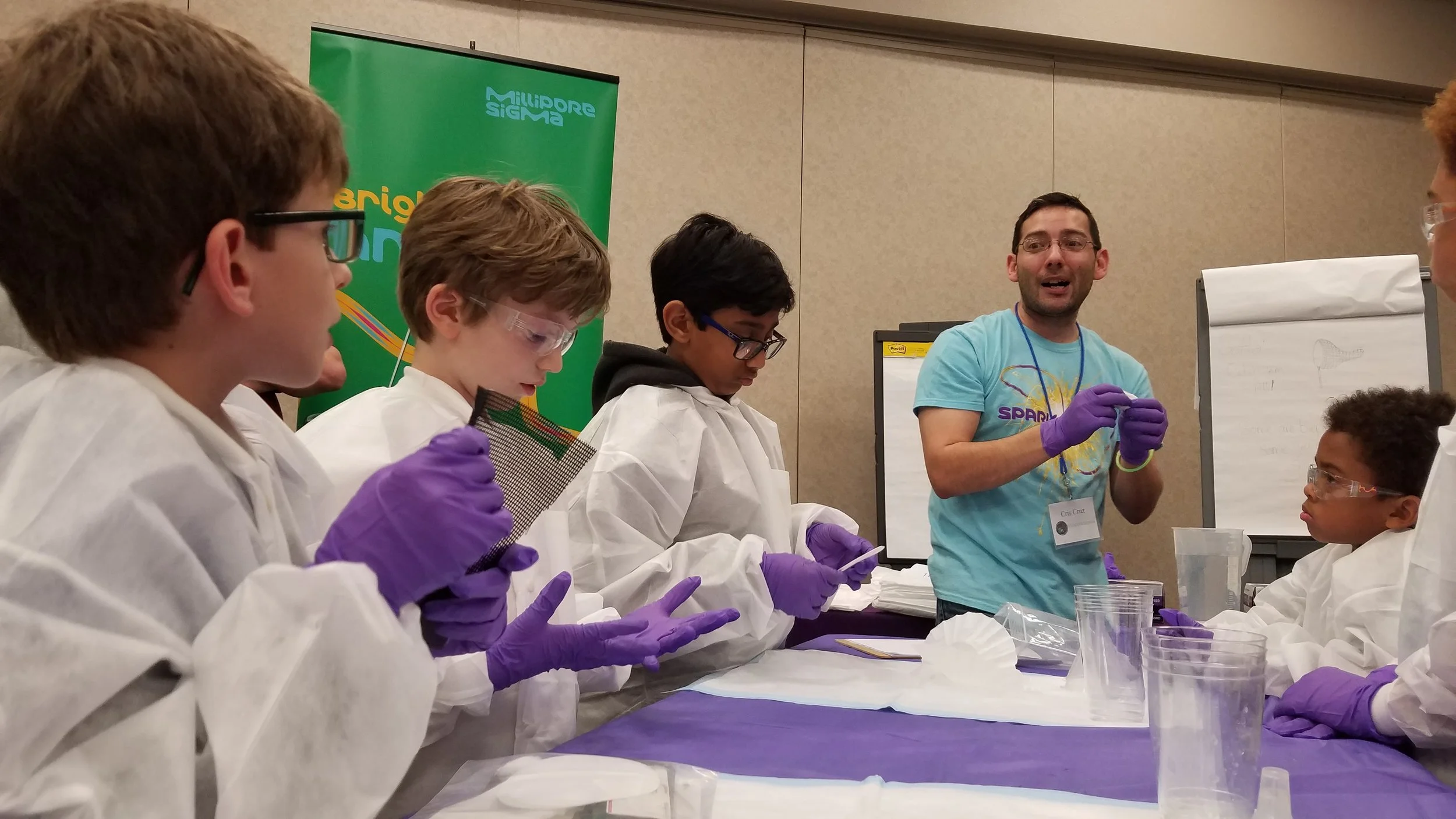 Pack 159 scouts join other scouts from the Capitol Area Council at the STEMboree, learning how to build a water filtration system.
