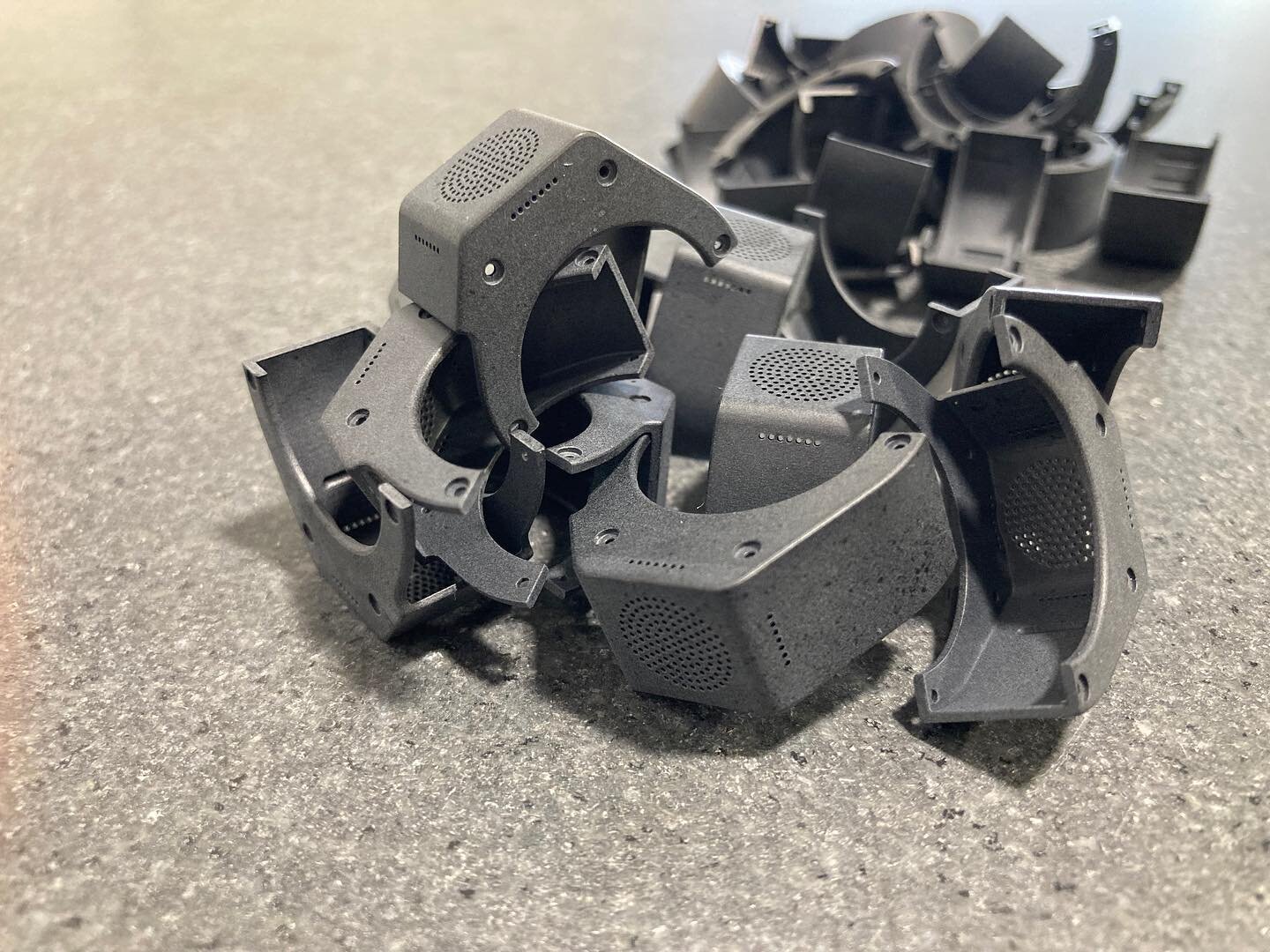 Here's a pile of black polycarbonate parts we machined last week. We specialize in prototypes and short run production of parts just like these! At first blush you might think these were injection molded. Nope, just machined from a whole lot of sides