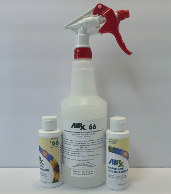 A large white spray bottle with a red and white nozzle, labeled 'AIRX 66,' and two smaller white bottles labeled 'AIRX 66 Bio-Enzymatic Foul Odor Digestor,' with sunflower imagery, all against a plain white background.