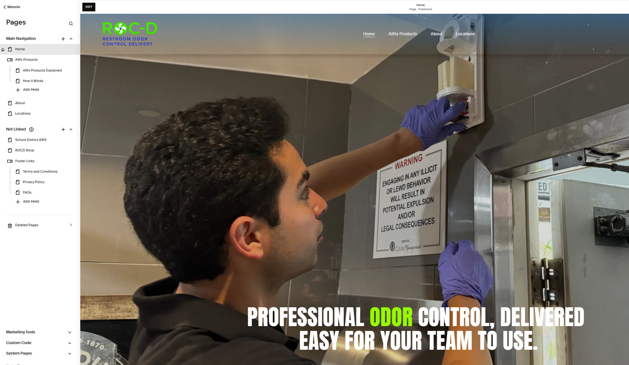 A person wearing purple gloves is installing or inspecting an electrical panel or control box on a wall.