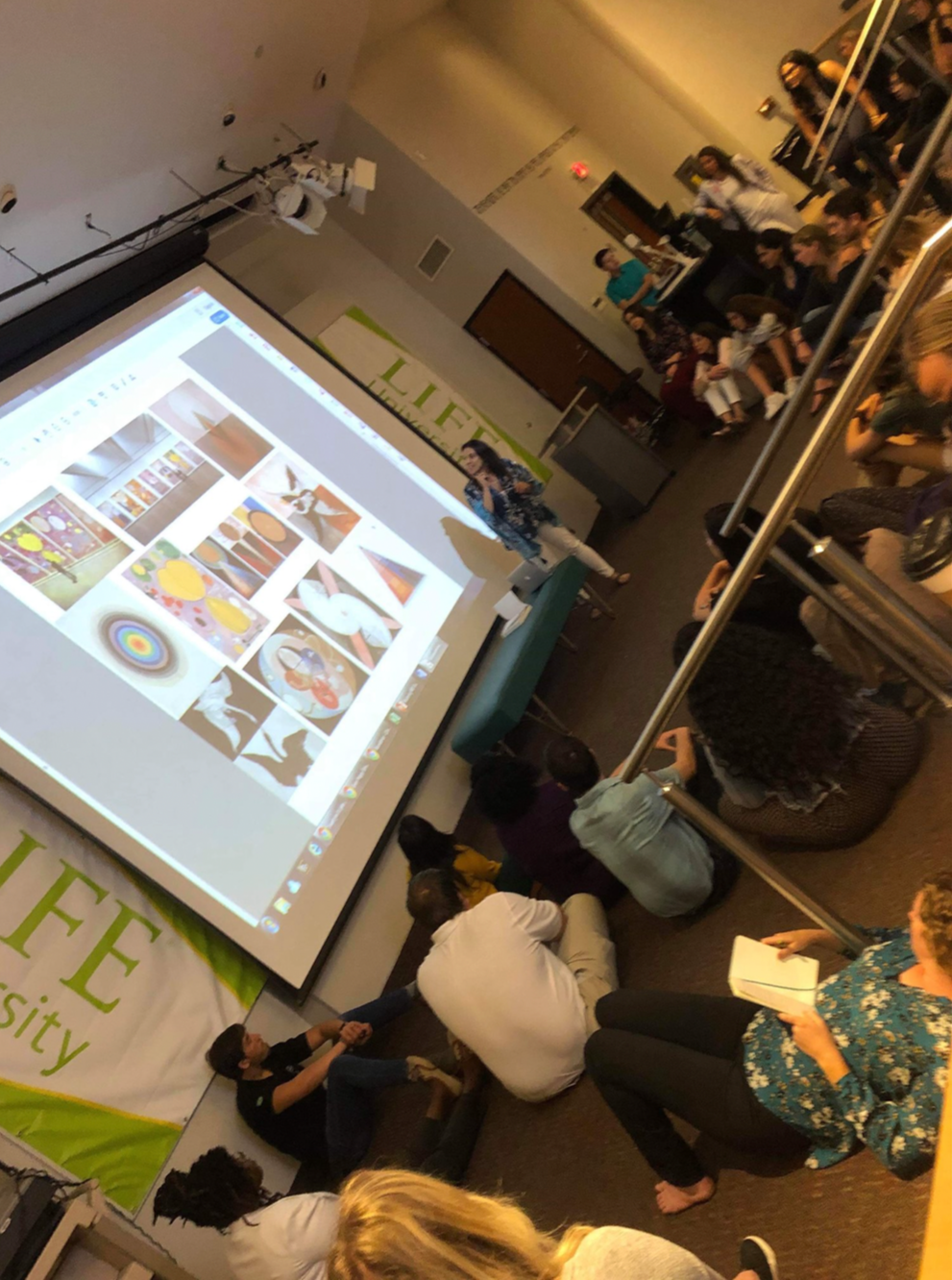 Dr. Sura Corrigan presenting on fertility and prenatal chiropractic care at a chiropractic college