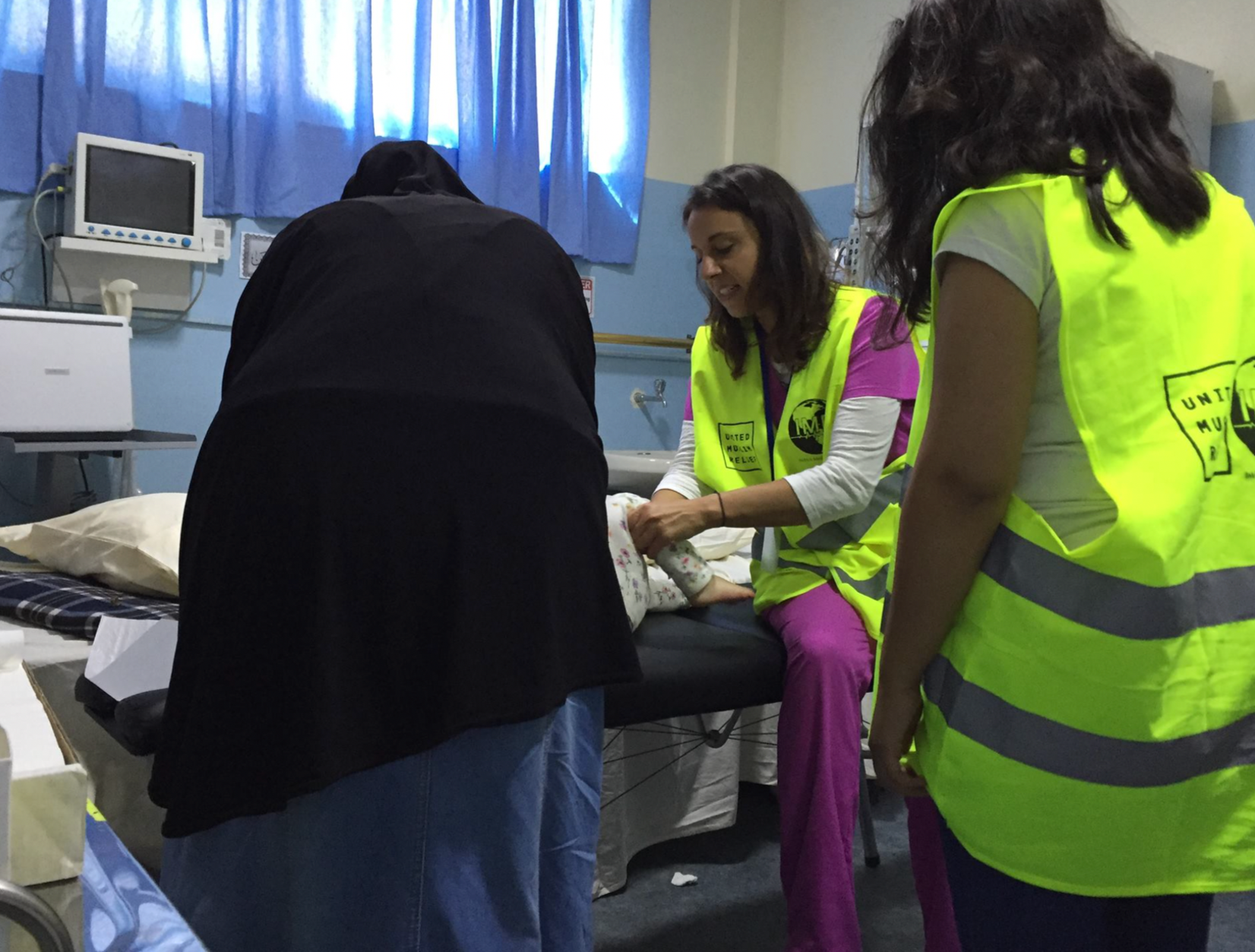 Dr. Sura Corrigan providing chiropractic care on a humanitarian mission supporting families and children