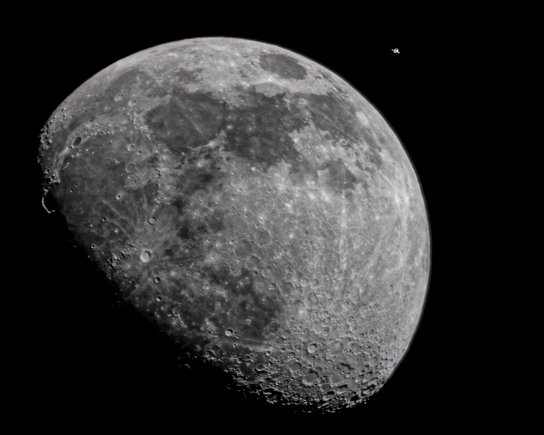 Iss passing in front of the moon