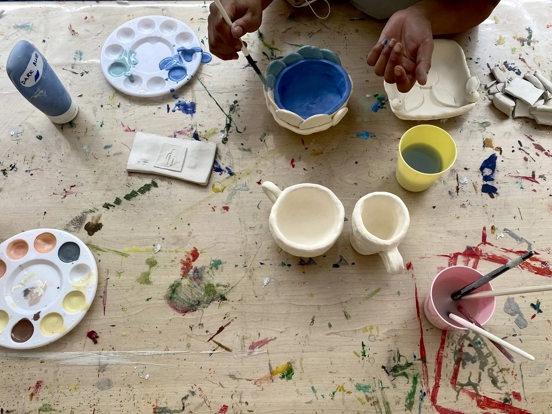 Pottery painting at Community Clay workshop.