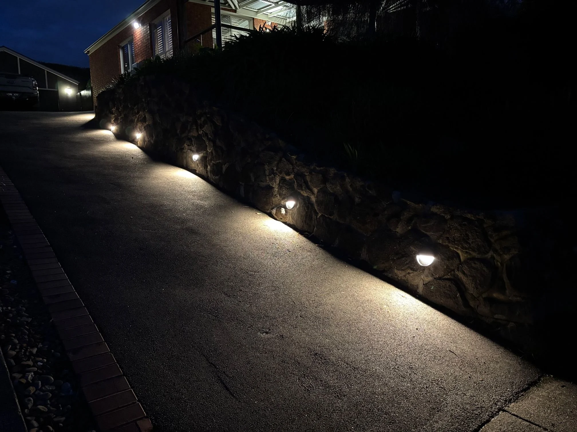 Driveway Lighting Upgrade in Plenty: Transforming a Rock Retaining Wall with Outdoor Lighting