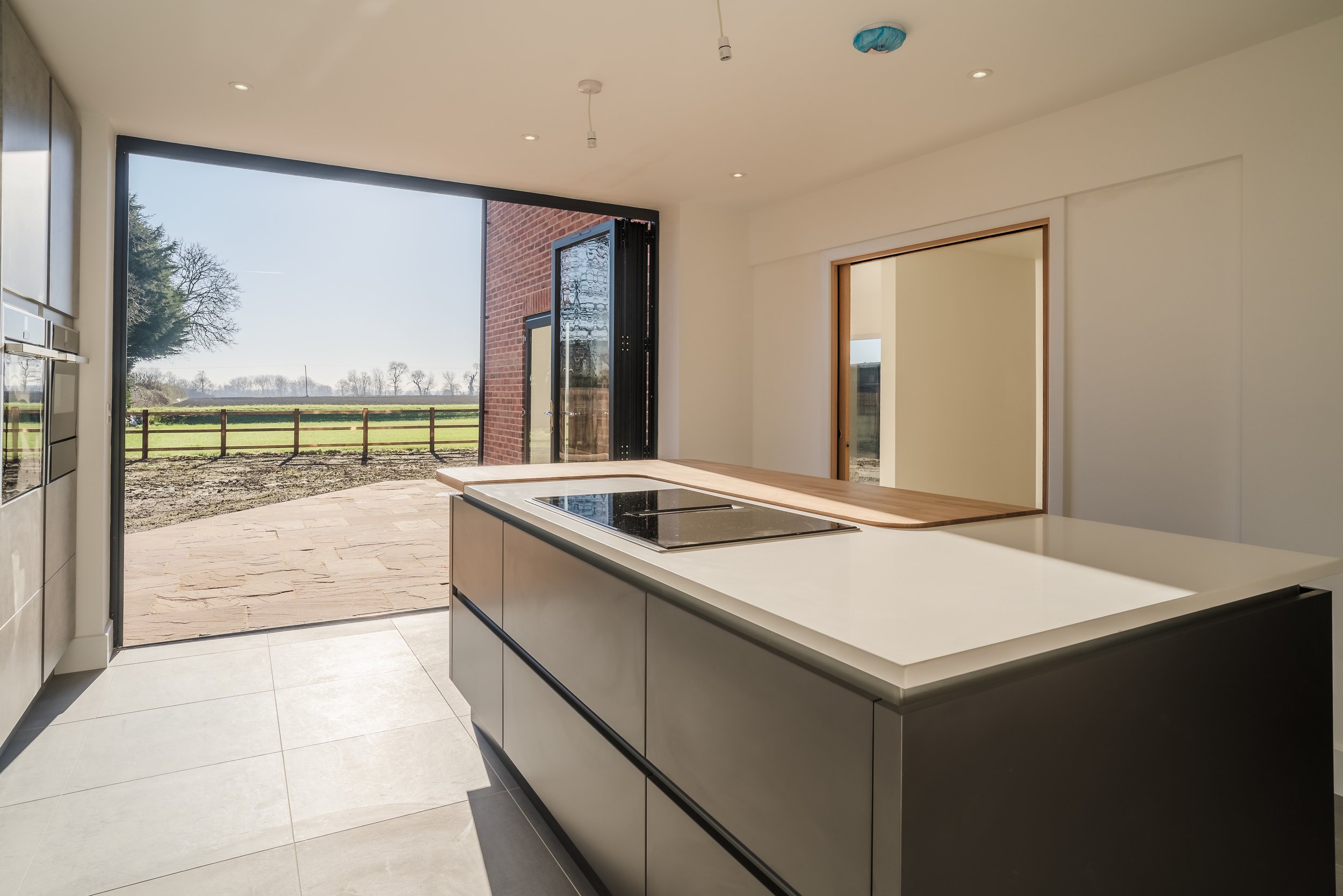 Kitchen folding doors - - new 5 bedroom home, Wilburton, Cambridgeshire.