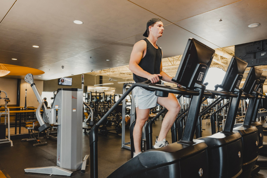 Member using stair climber cardio equipment on the fitness floor at Club Apple health club in Idaho Falls.
