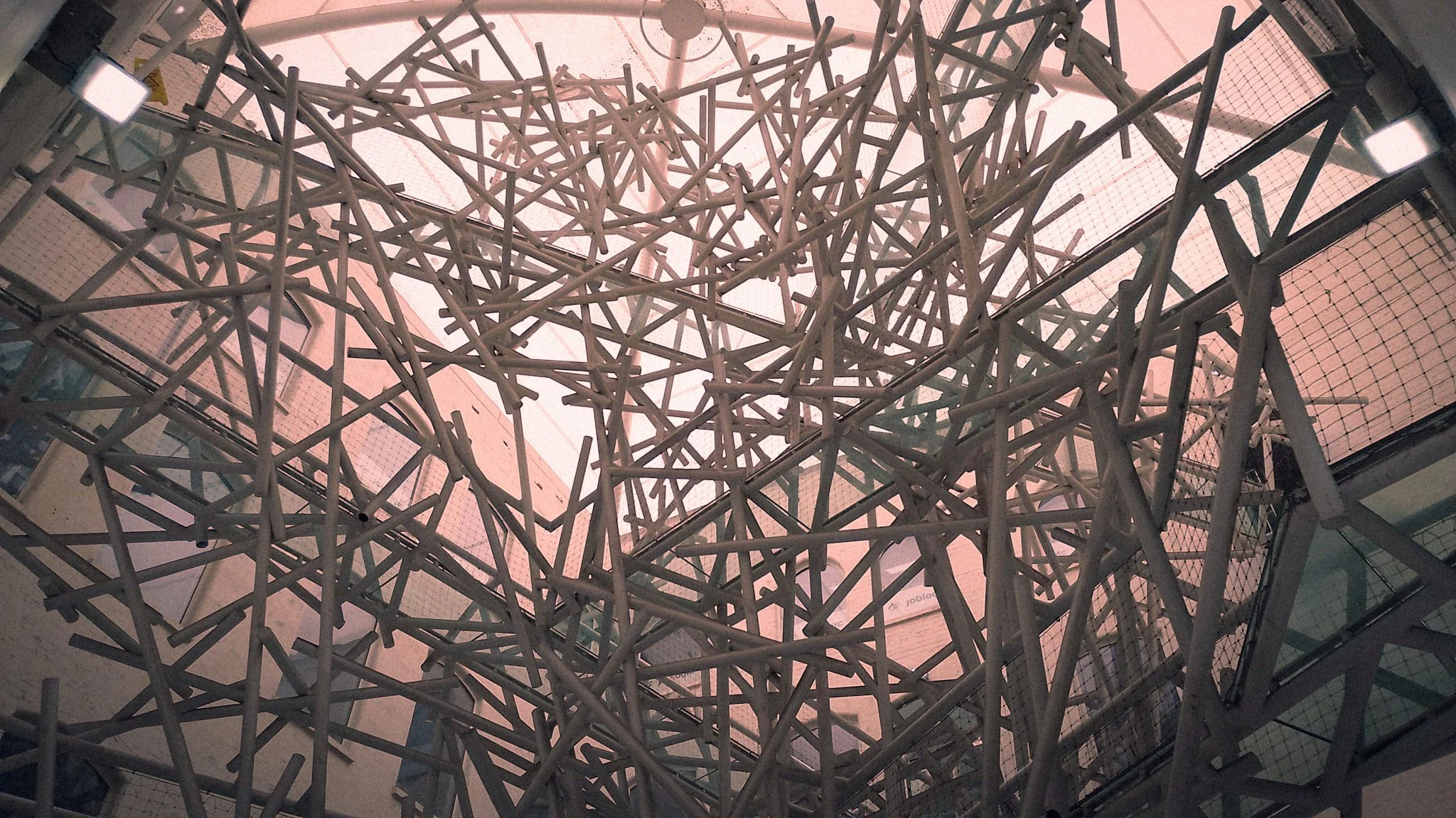 Integrated artwork "Chaos" in building foyer lit with natural light.