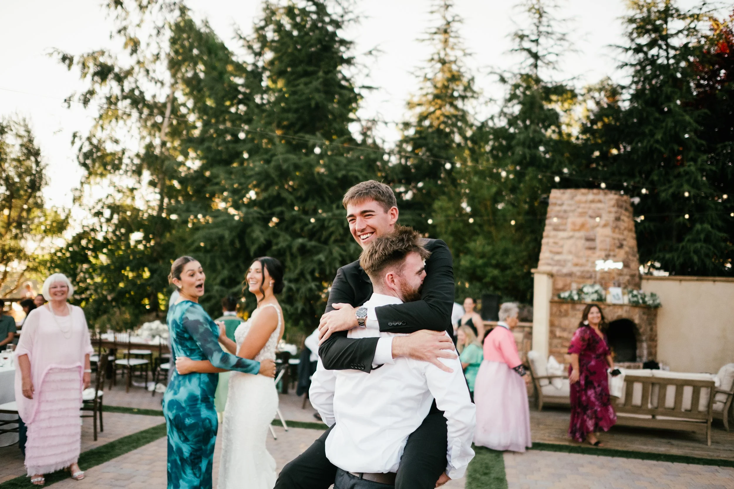 groom enjoying dancing with a groomsmen at the reception
