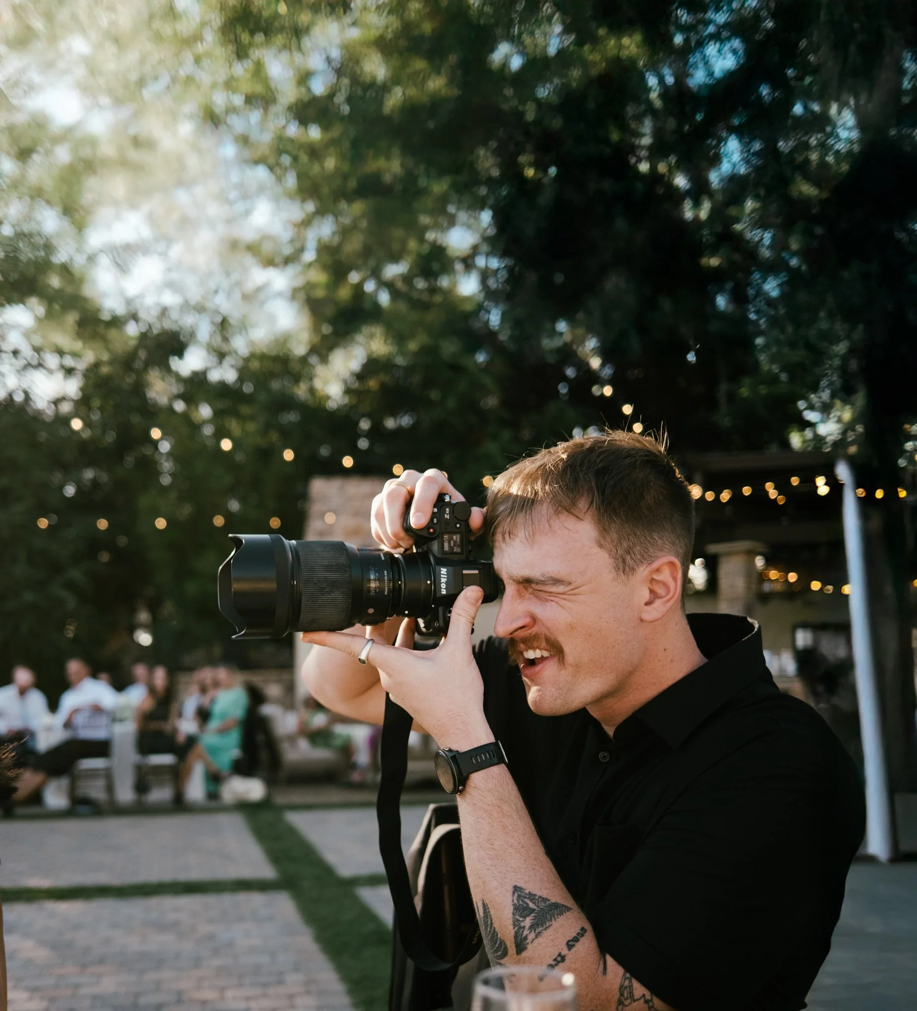 portrait of wedding photographer with camera in hand. based in brisbane, australia