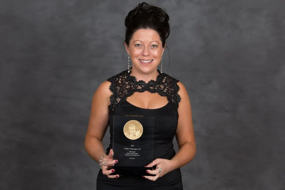 Amy Cherry accepts WDEL’s “Overall Excellence” Edward R. Murrow Award .