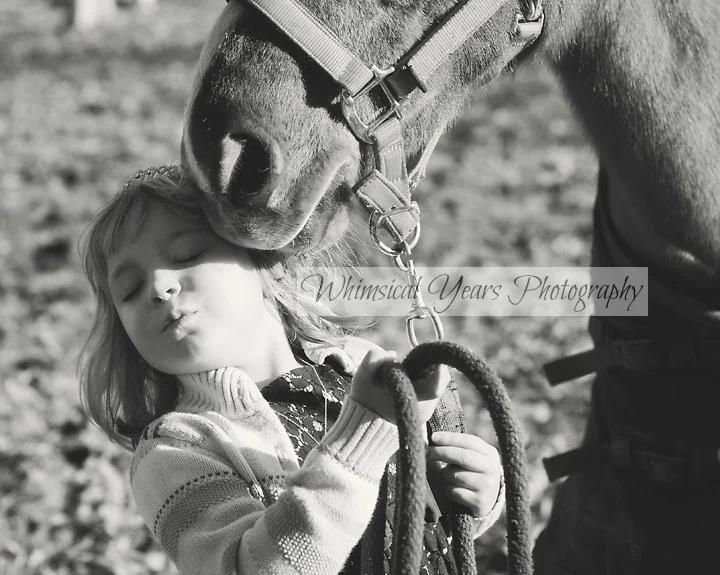 black and white photo of little girl and horse