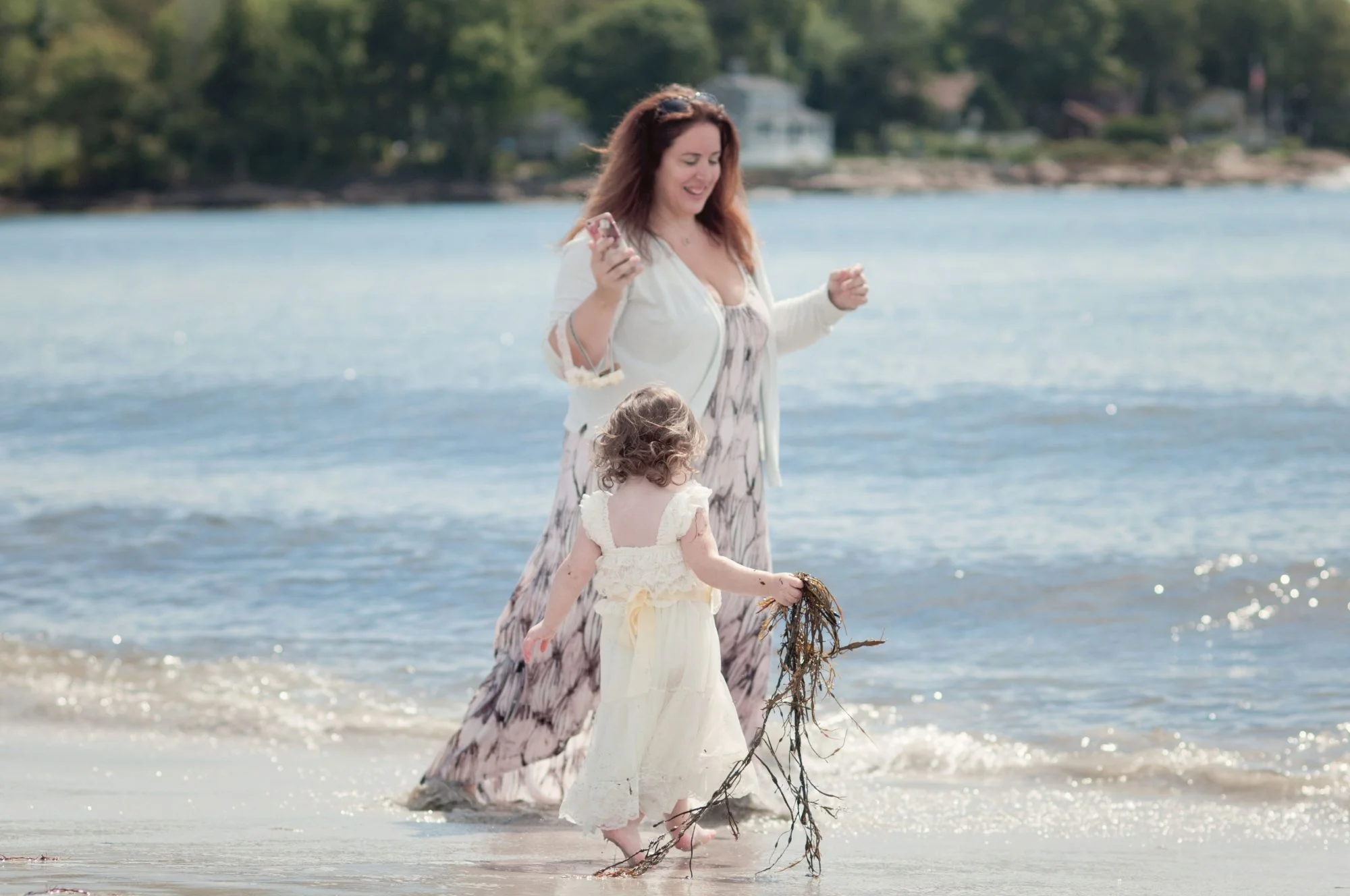Mother and daughter playing on the beach
