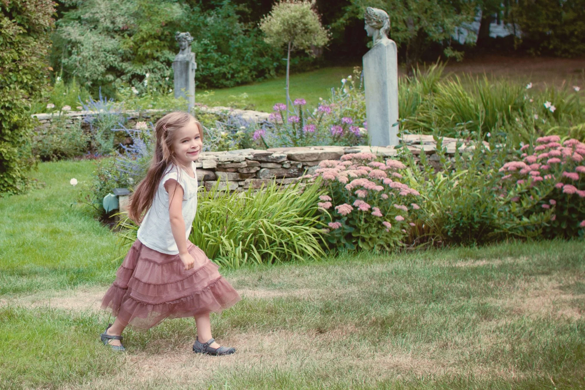 Little girl running through gardens at Clark's Cove Farm