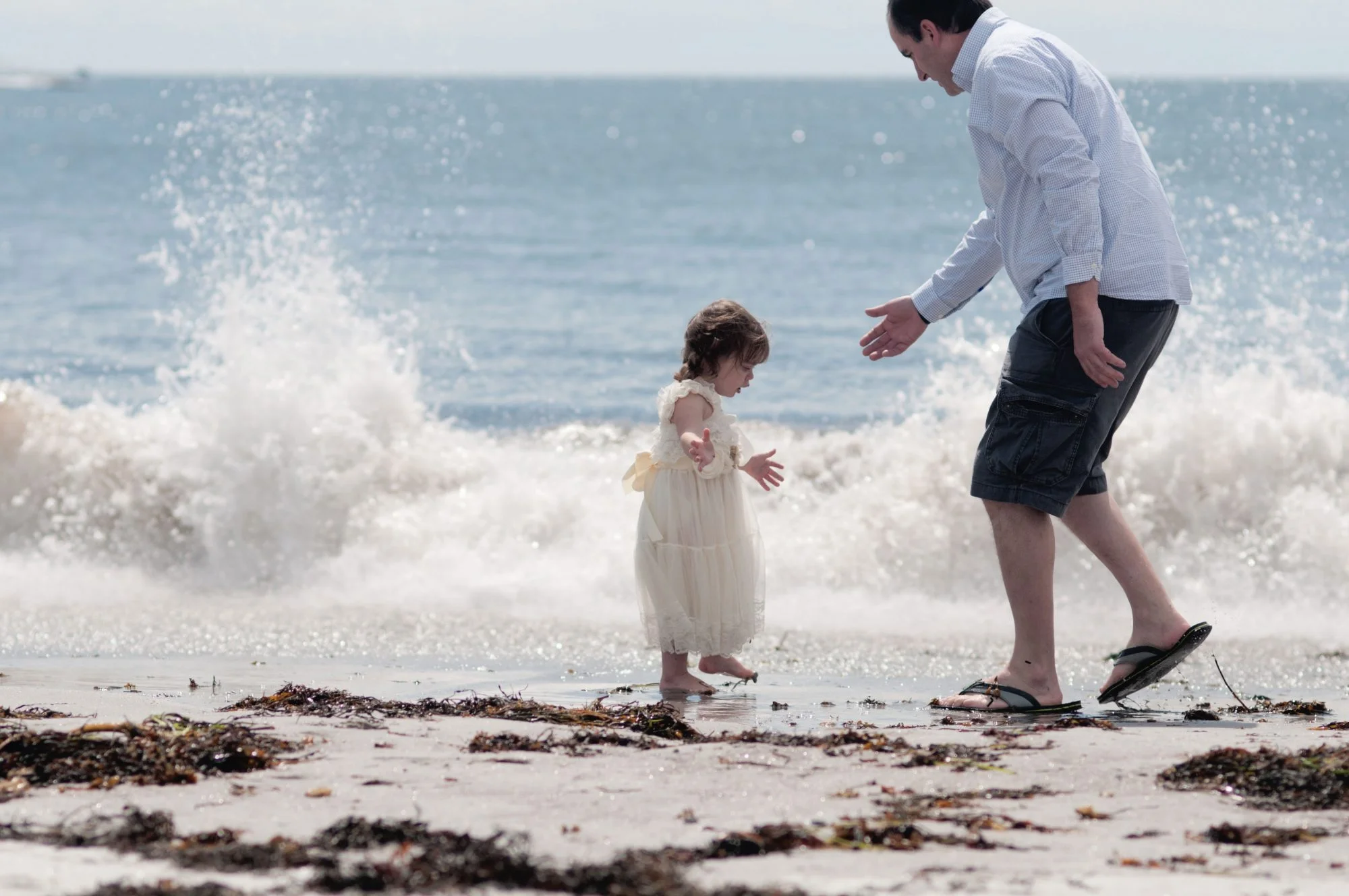 Child and father playing in the water at Pemaquid Beach