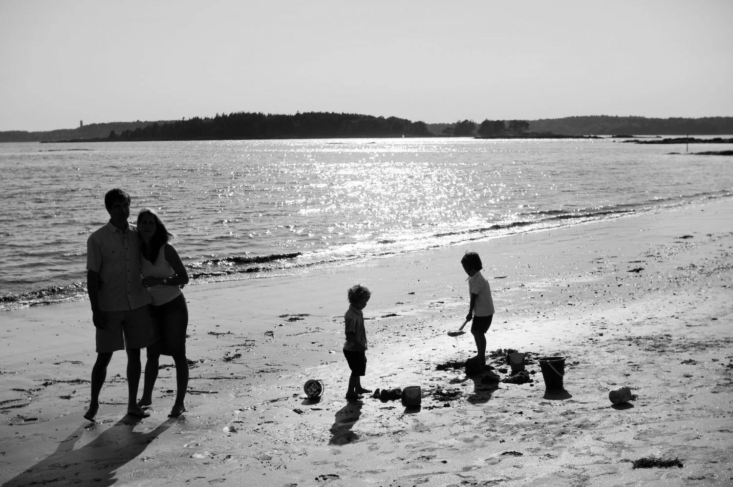 Black and white silhouette photo of family at Pemaquid Beach