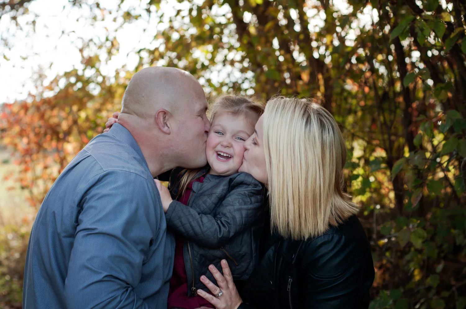 cute portrait of young family in the fall