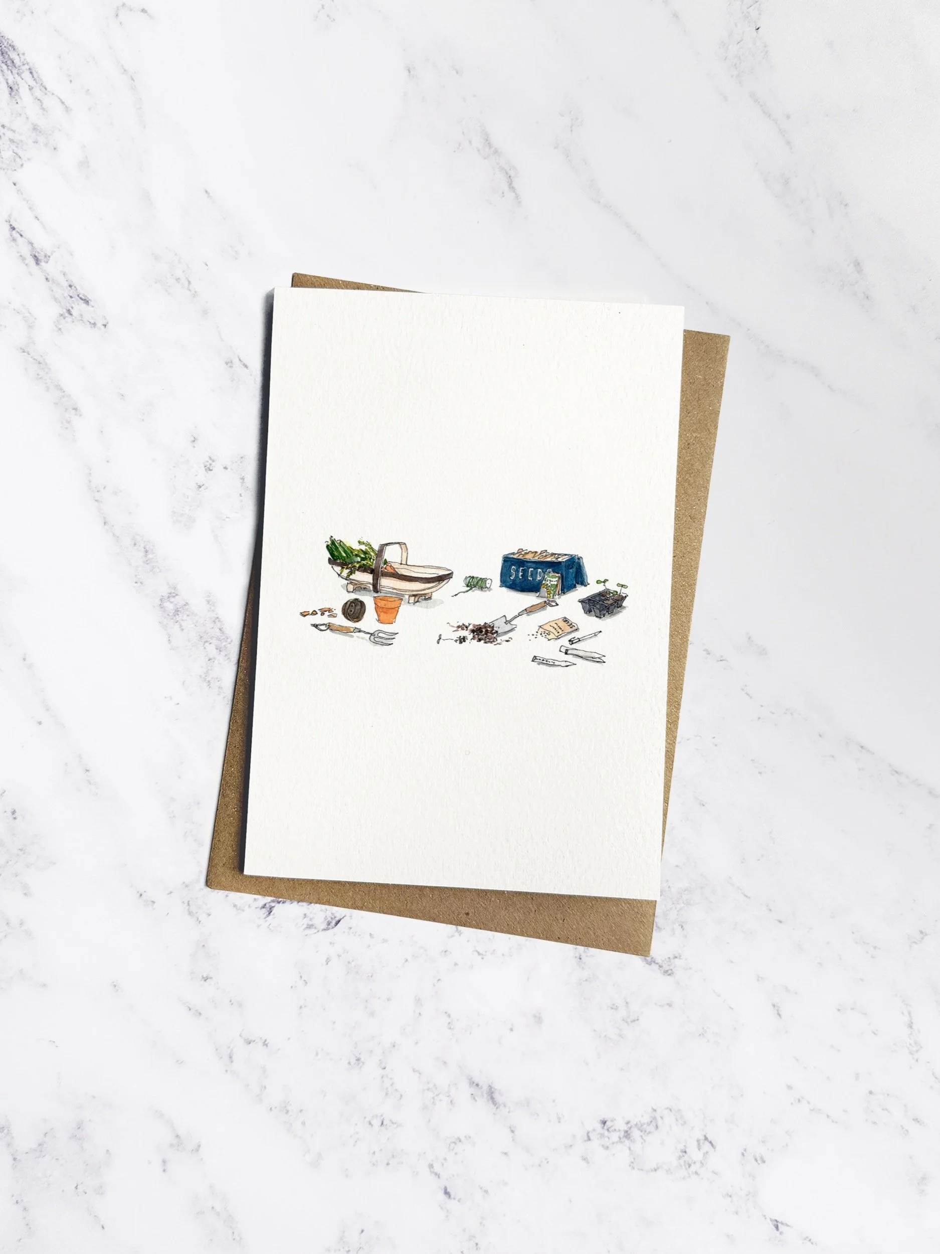 A beautifully illustrated gardening-themed greeting card featuring hand-painted watercolour tools, seedlings, and plant pots. Displayed on a marble background with a kraft envelope tucked behind.