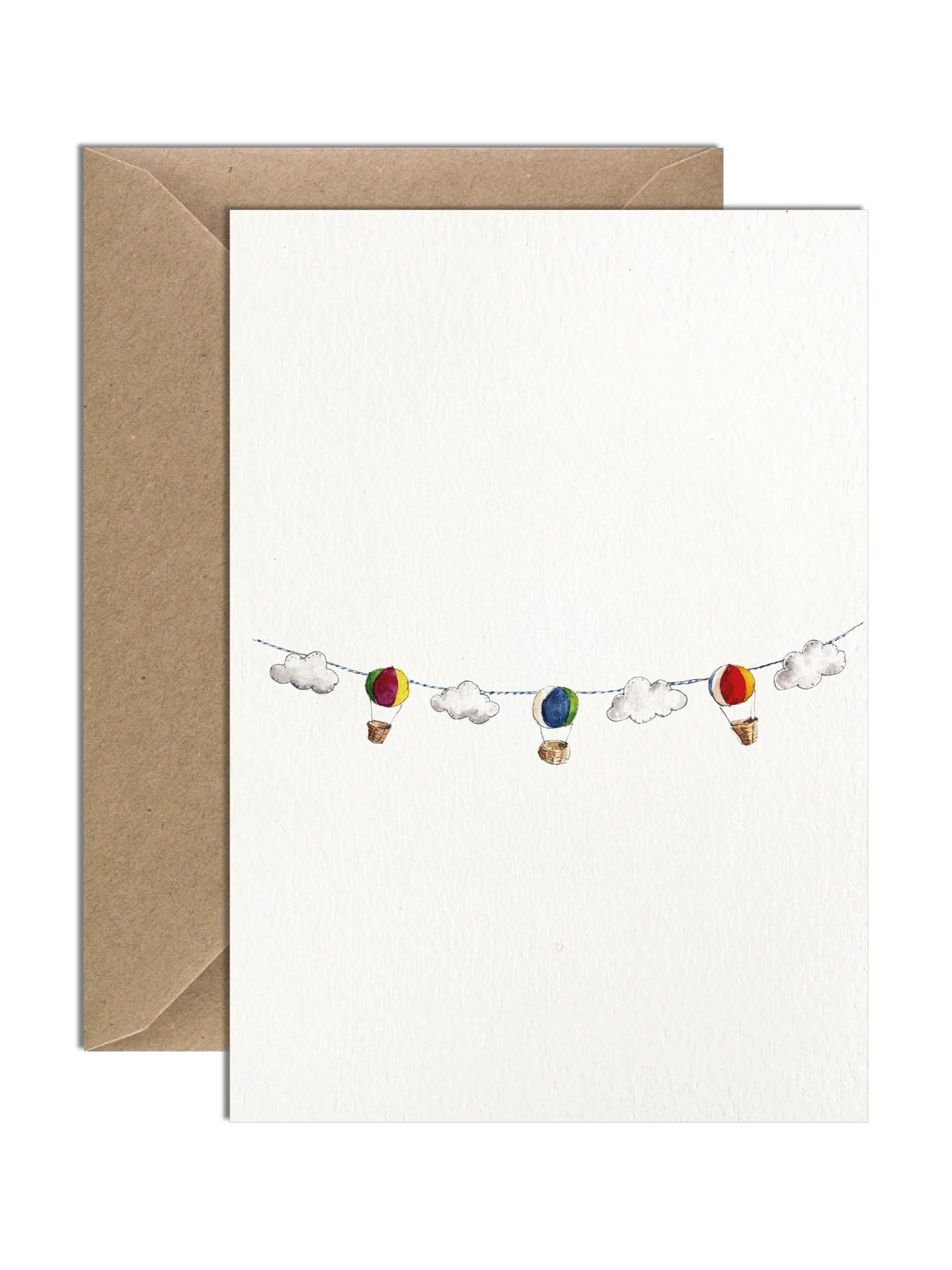 Greetings card showing a watercolour illustration of a beautiful handmade felt hot air balloon and cloud garland. There is a brown kraft envelope tucked behind the card.
