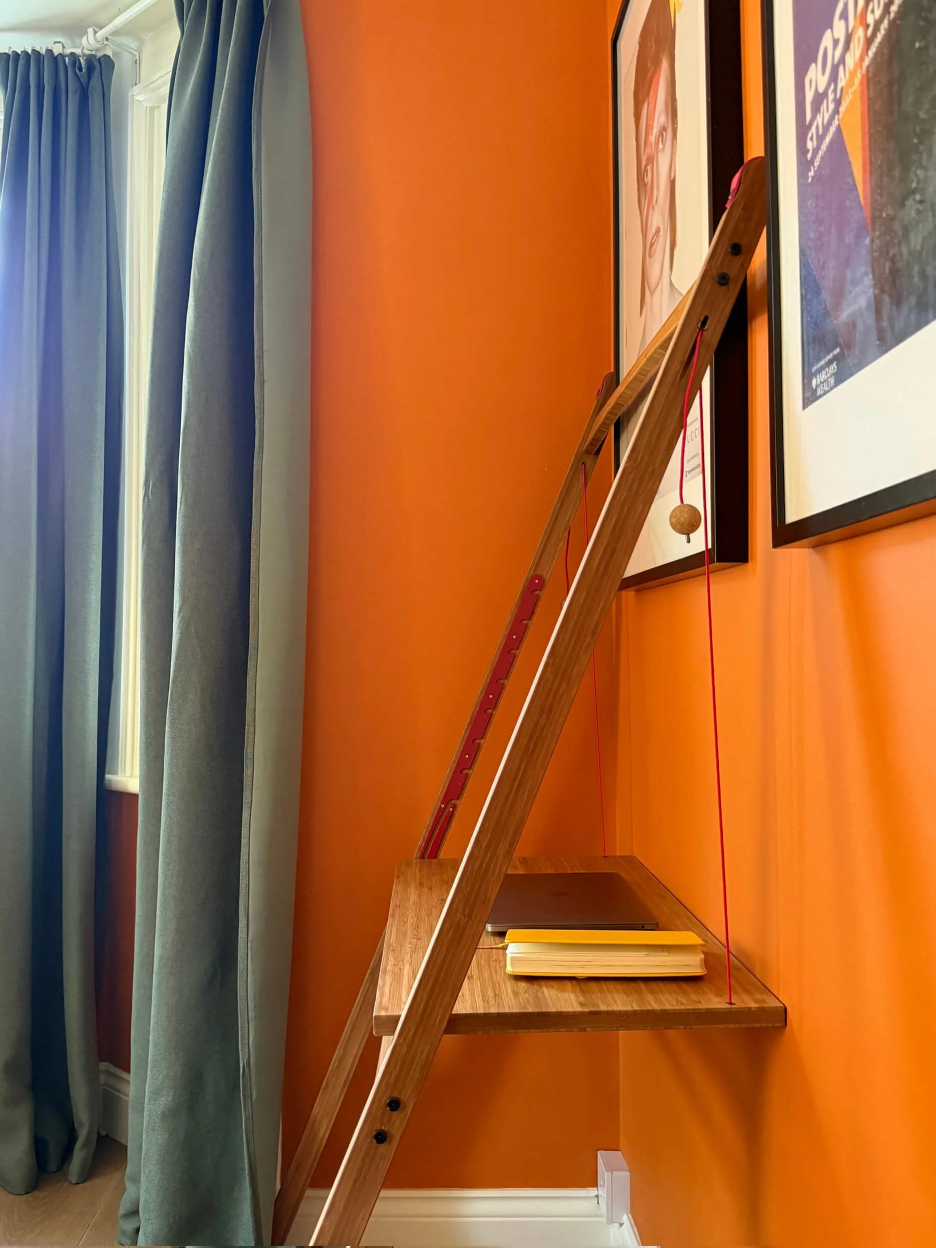 Leandesk shown from the side, set up in a seated position with the bamboo frame and red support cords visible