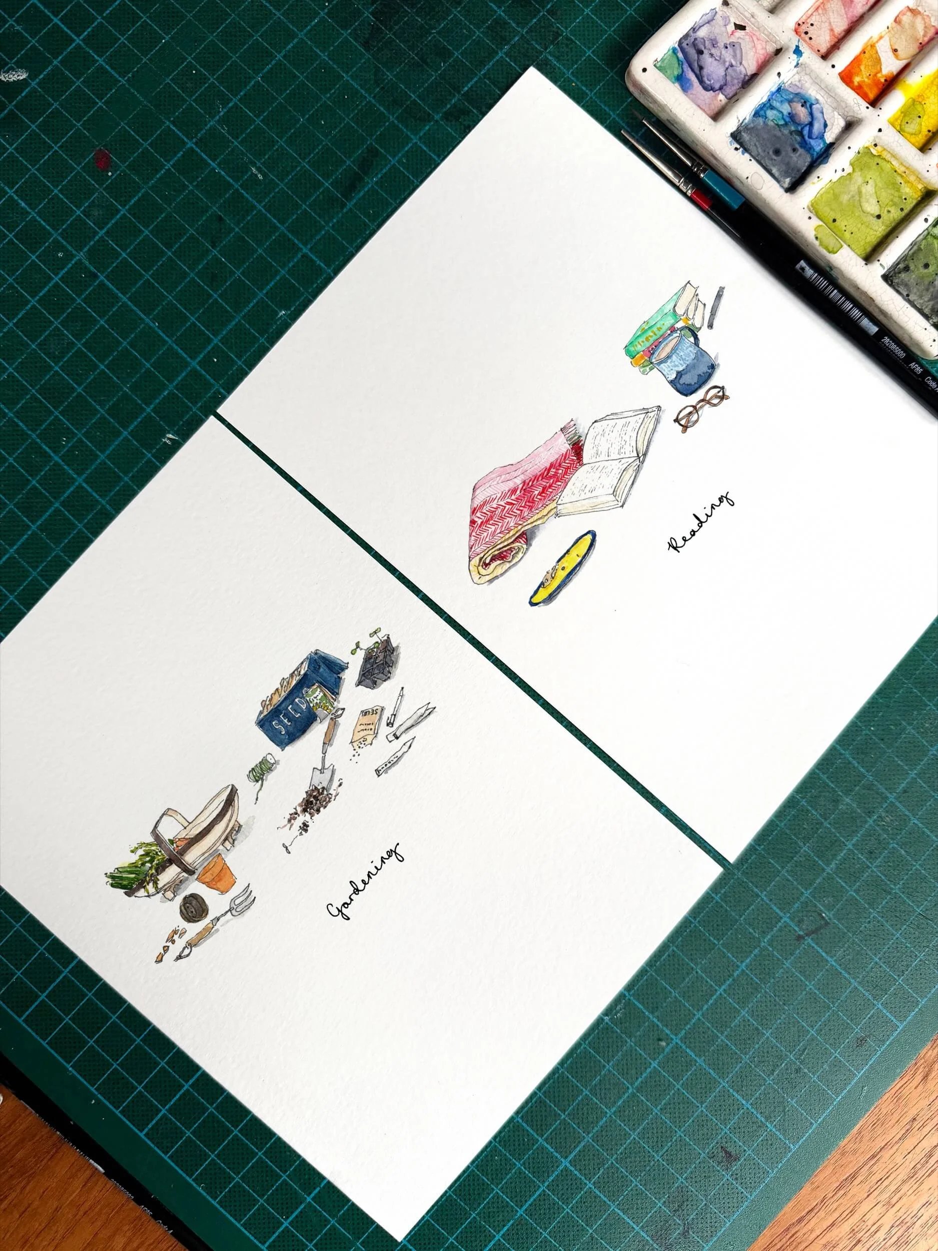 Two pages of illustrations, one with a set of gardening tools, the other a book and other lovely reading items. Taken from above on a green background, there is a used paint palette to the side.