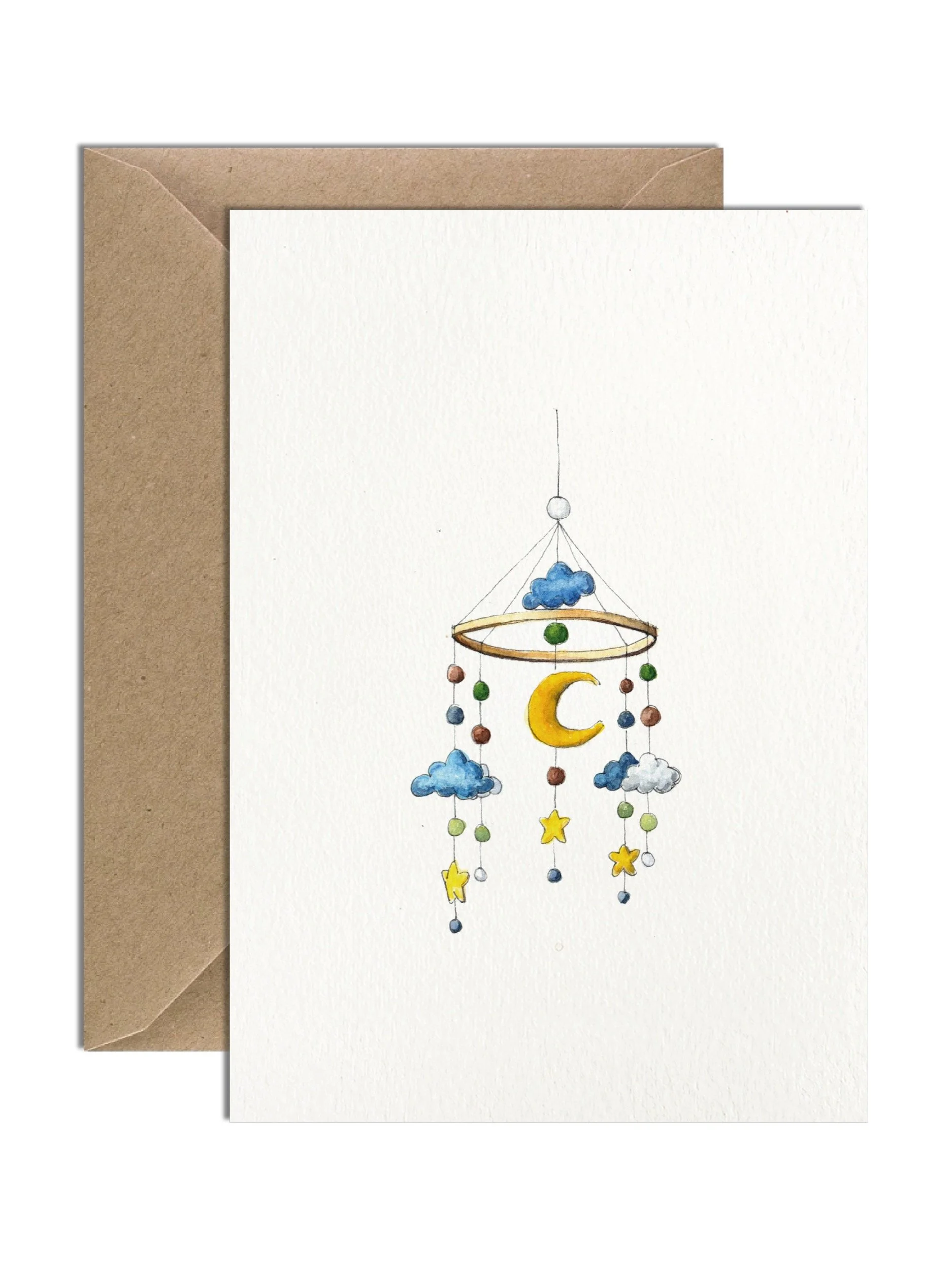 A beautiful felt baby mobile carefully captured in delicate watercolour illustration. The illustration sits in the centre of an off white greetings cards with a kraft envelope behind.