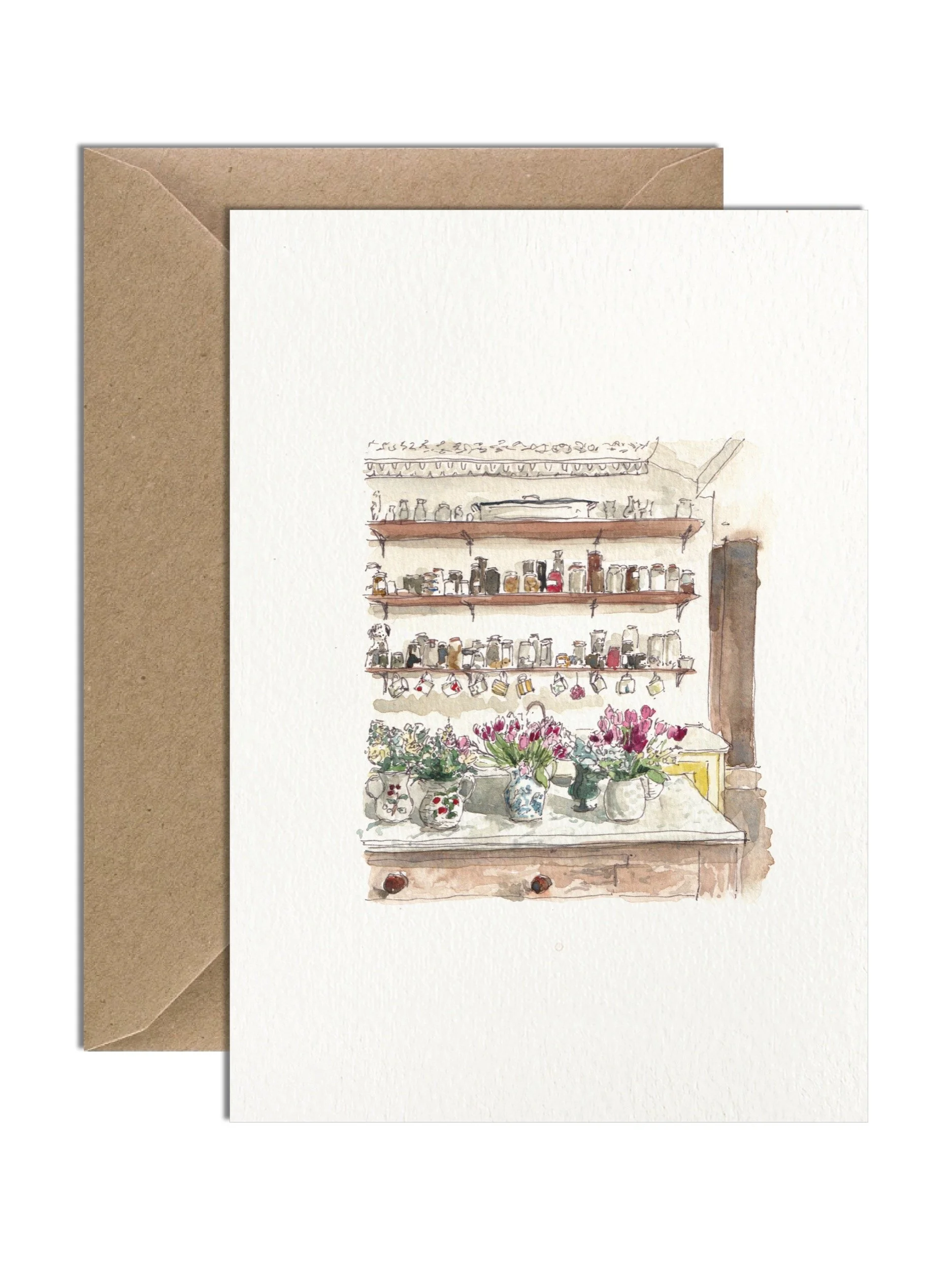 A delicately intricate hand painted watercolour illustration of flowers in jugs on a kitchen table. The charming greetings card is on a white lightly textured card with brown kraft envelope behind.