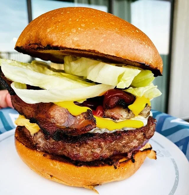 The Old Backyard Burger cooked over charcoal on a shitty Weber grill. The flavors of this damn thing are so nostalgic and satisfying. Bacon, American Cheese, Swiss, Lettuce, Red Onion, Relish, Mustard and Ketchup on a Toasted Brioche Bun.