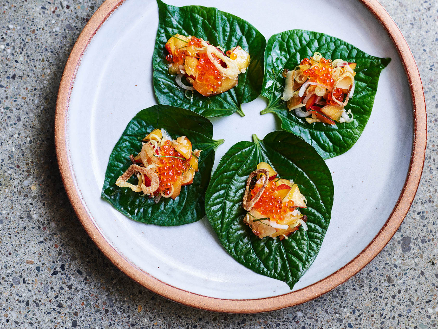 orange-fish-roe-on-a-vibrant-green-leaf.jpg