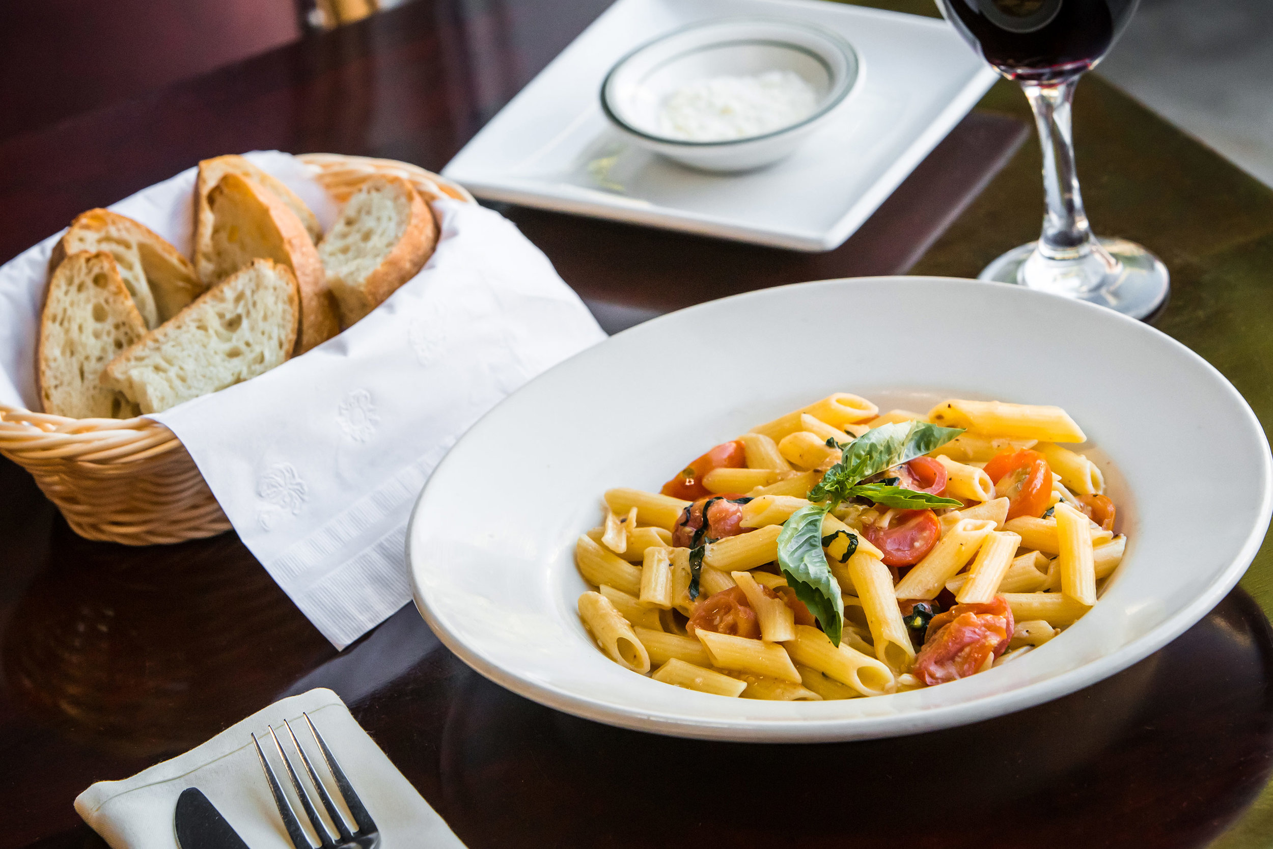 penne pasta dish with bread