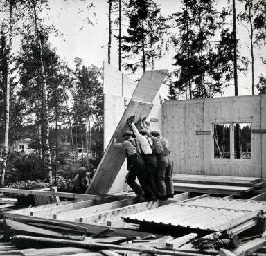 Finnish workers complete a house for WWII refugees