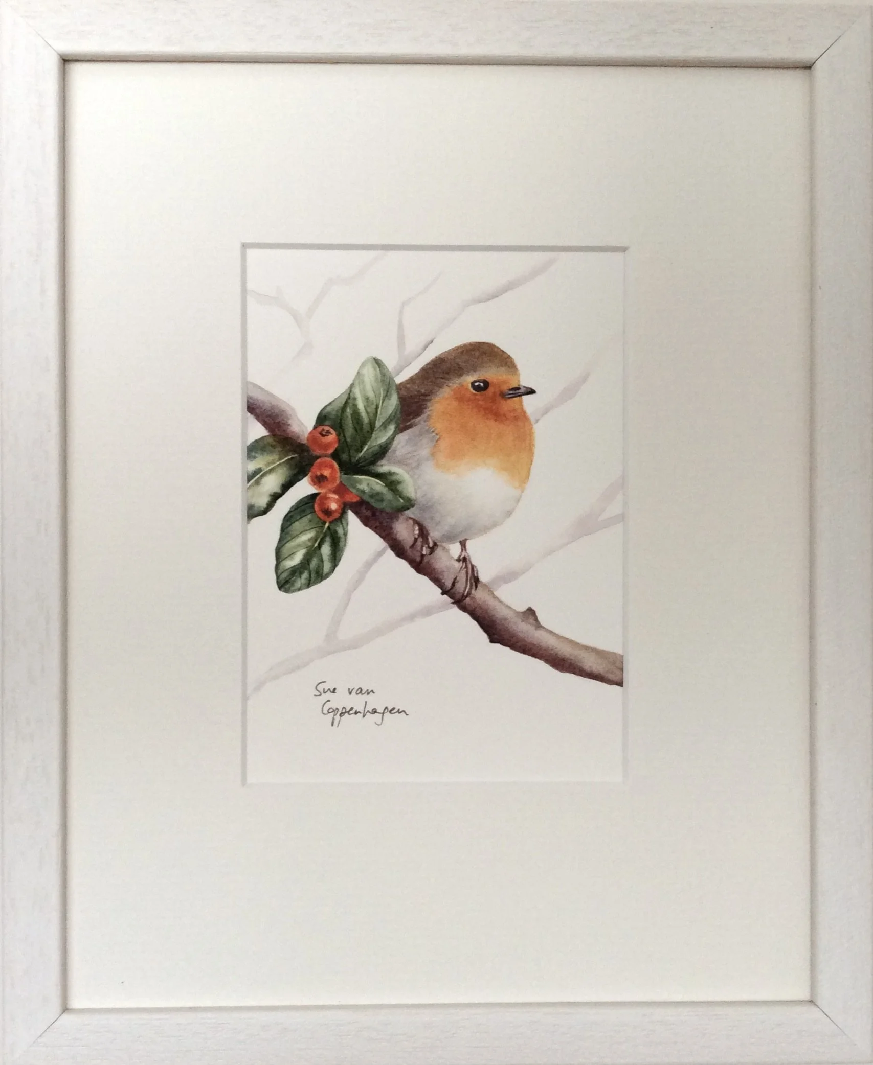 Framed painting of a robin bird on a branch with green leaves and red berries