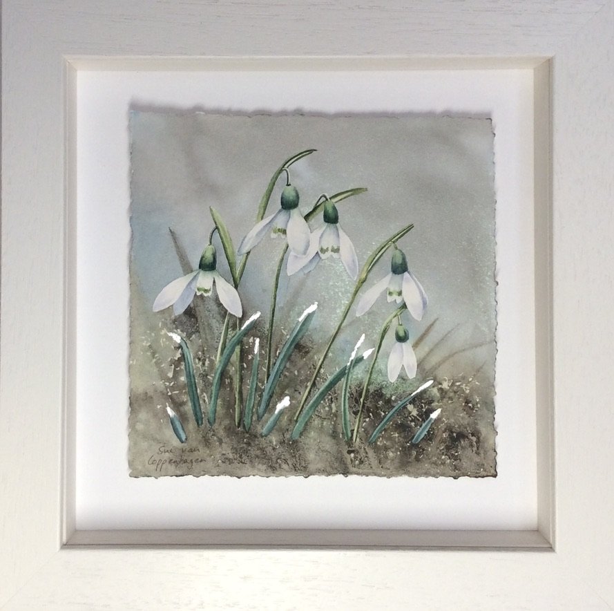 Painting of white snowdrop flowers on a grey background in a limed wooden frame