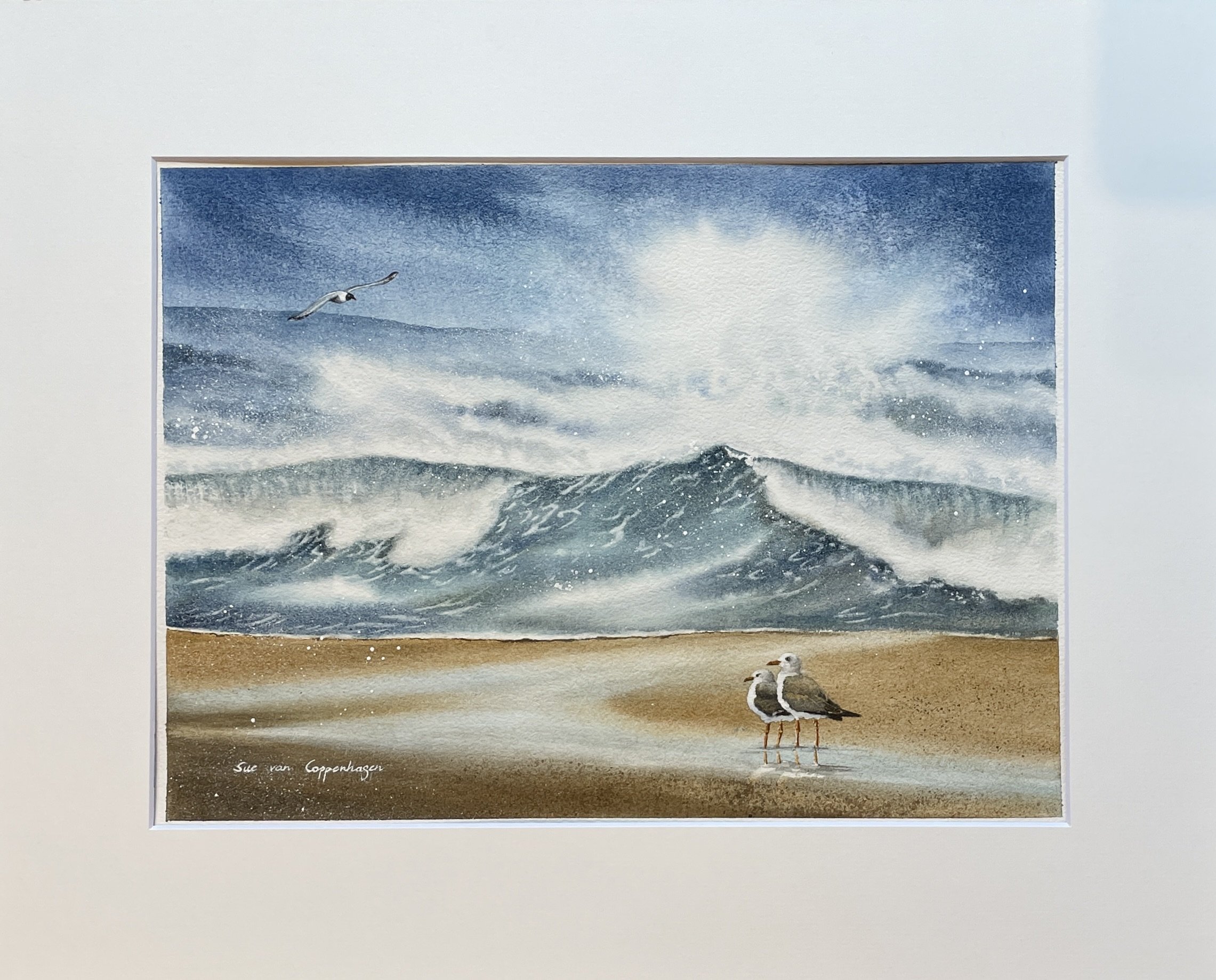A mounted seascape painting of ocean waves and gulls