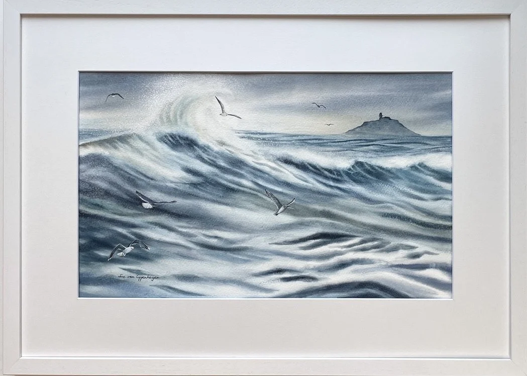 Framed watercolour painting of Ballycotton island above a sea of waves and spray and with gulls whirling in the air