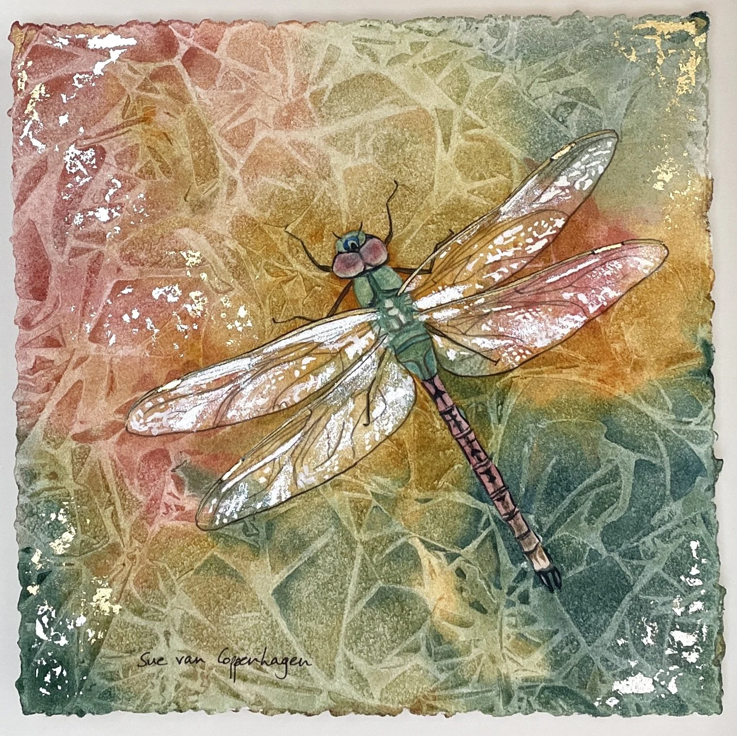 Painting of a dragonfly with green and russet body and shimmering wings on an abstract background of cellular shapes in gold, reds and greens, with touches of gold leaf applied