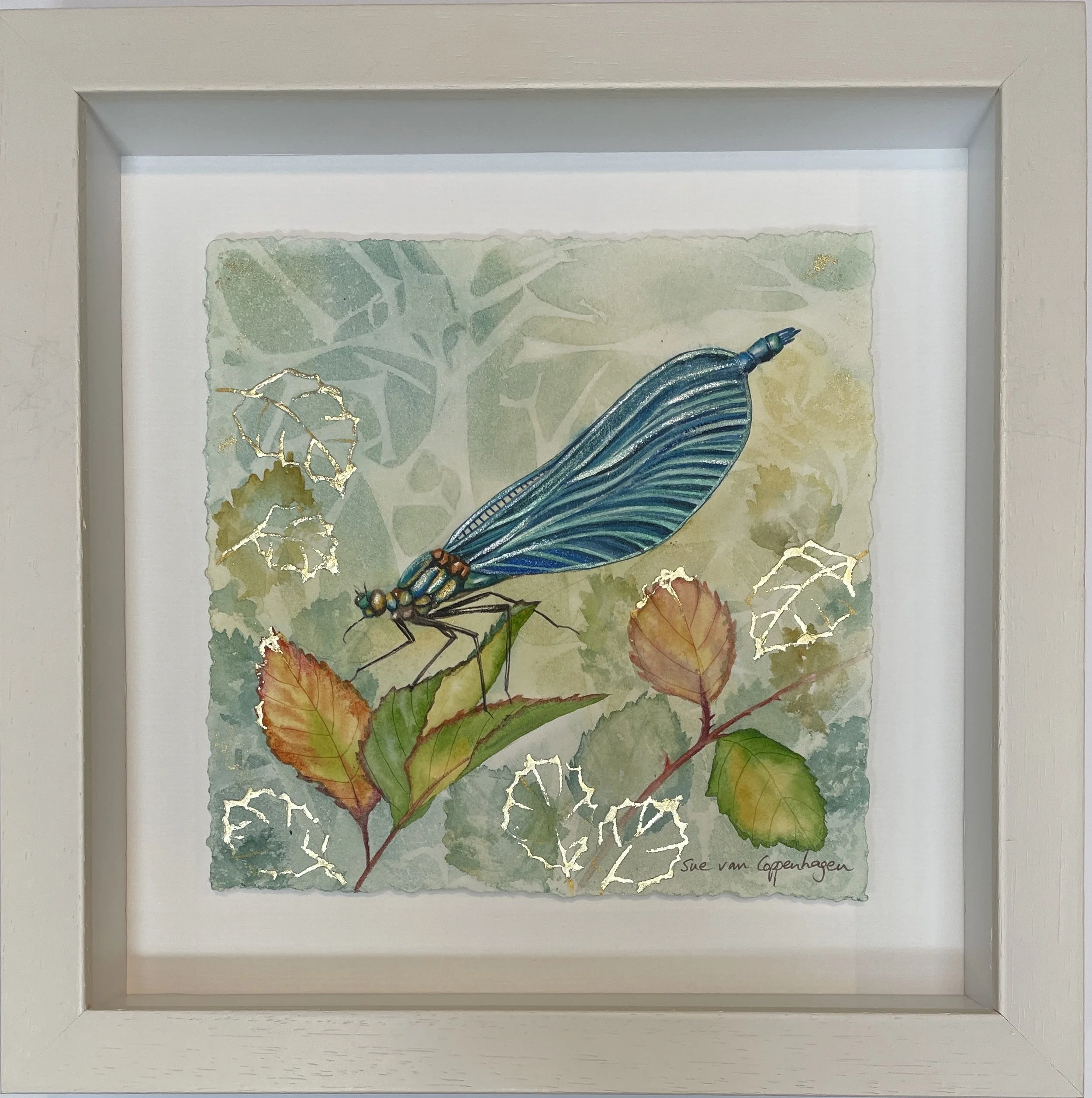 Framed painting of a beautiful demoiselle damselfly with blue wings on a blue green and gold background