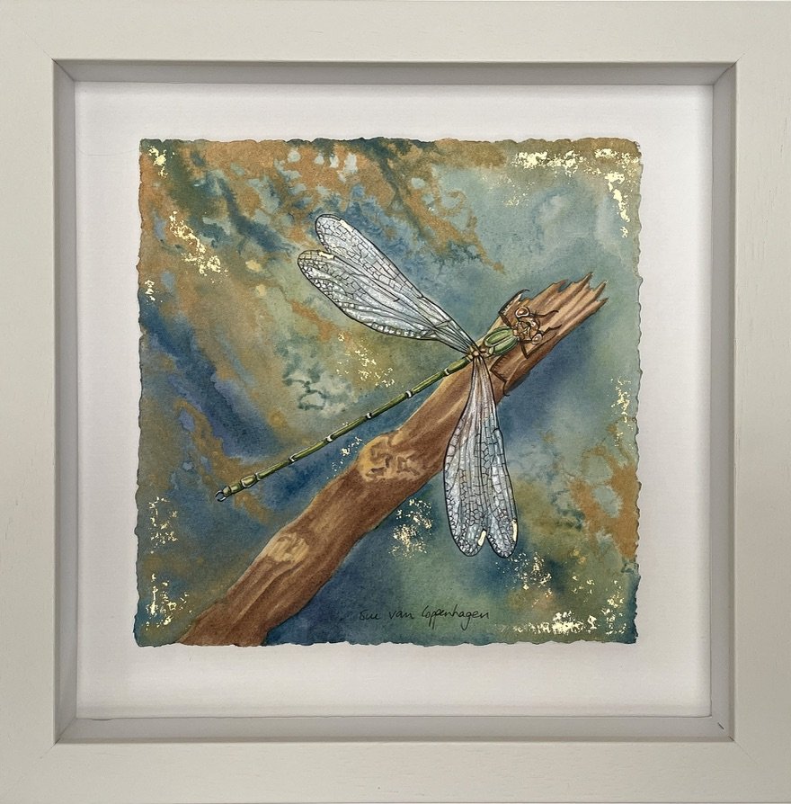 Framed painting of a green damselfly on a background of blue, green and gold