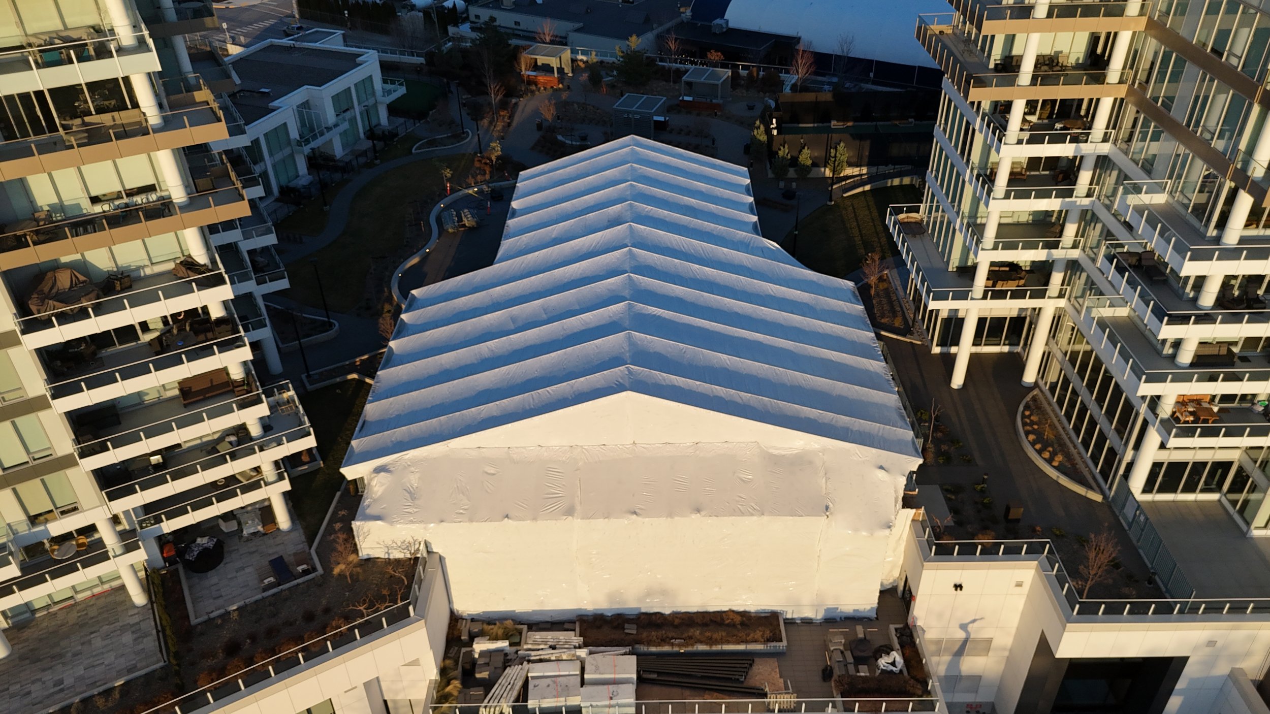 Keder Temporary Roof System installed by Hex Scaffolding Inc. over the One Water Street courtyard in Kelowna, BC, providing weather protection for commercial construction.