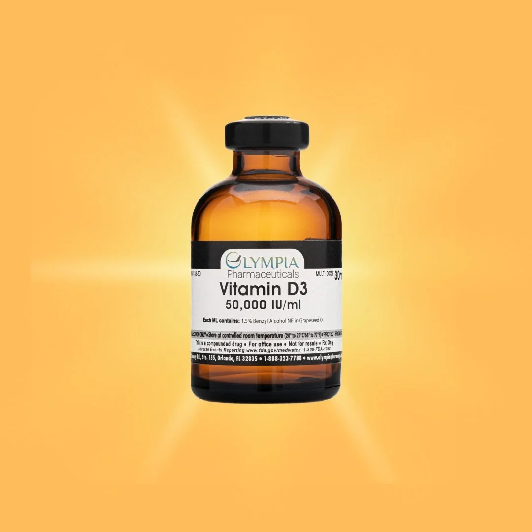 Amber glass bottle labeled Vitamin D3 supplement from Olympa Pharmaceuticals against a yellow-orange background.