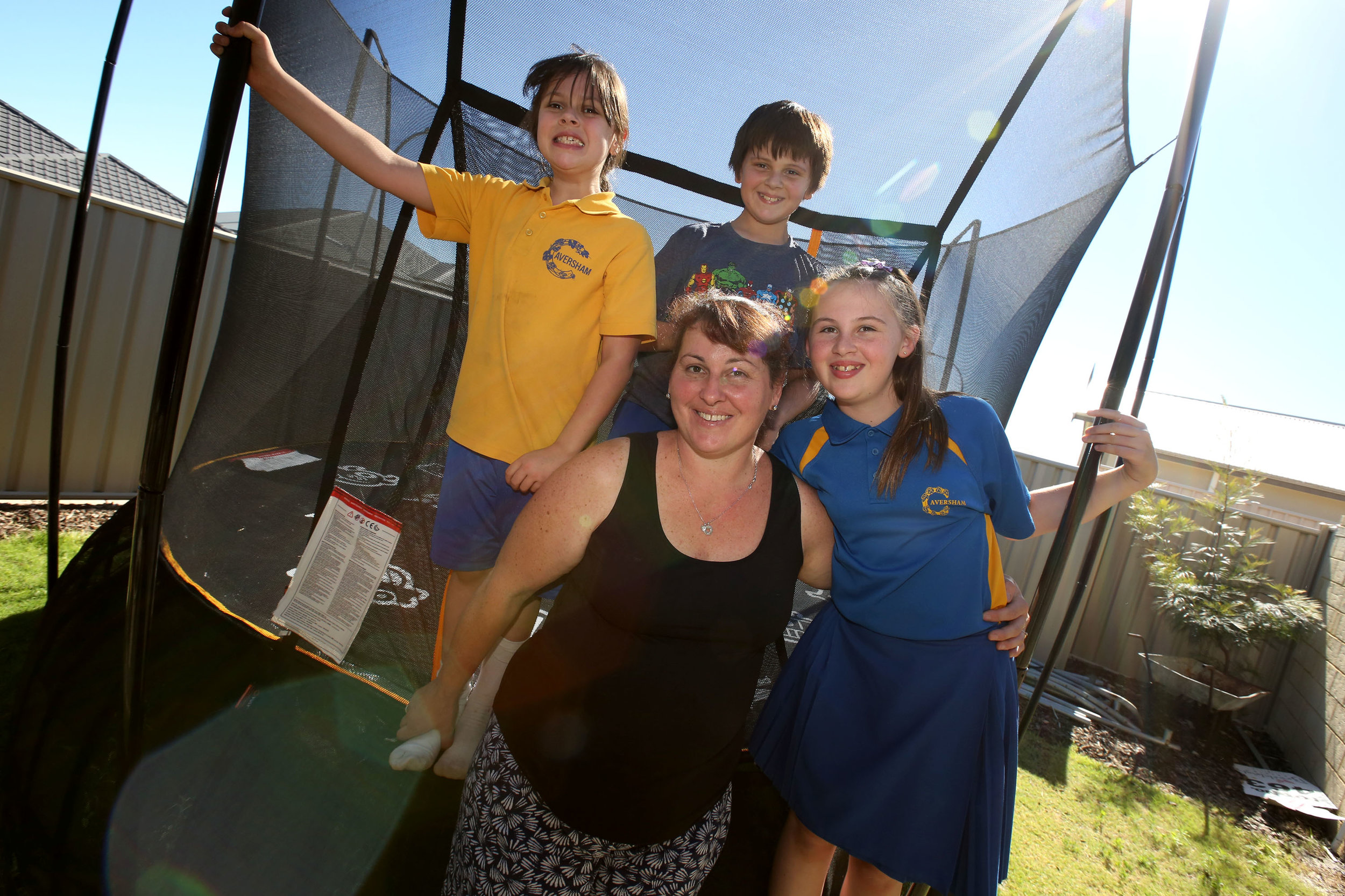 family standing in front of trampoline