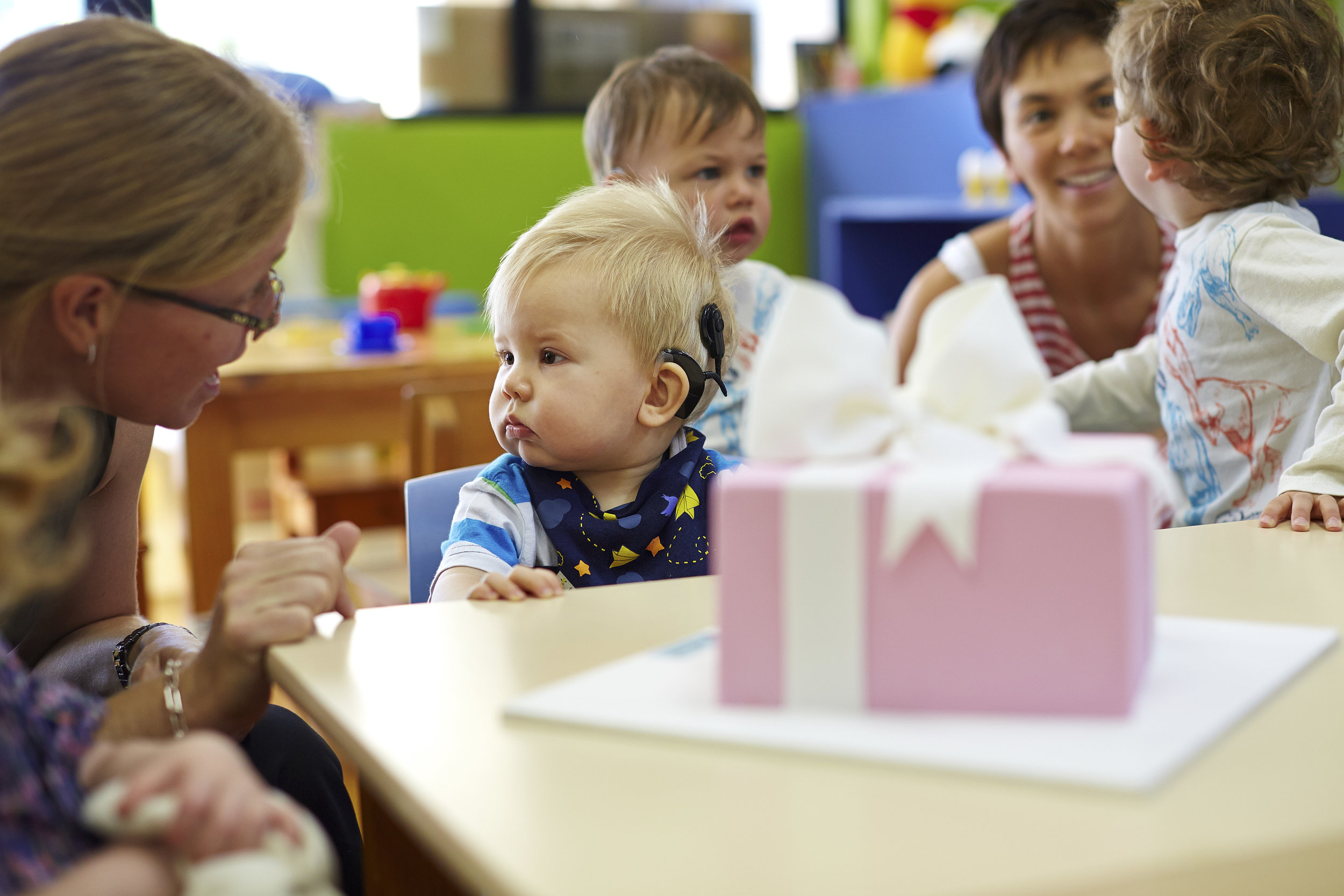 boy with hearing aid with other people