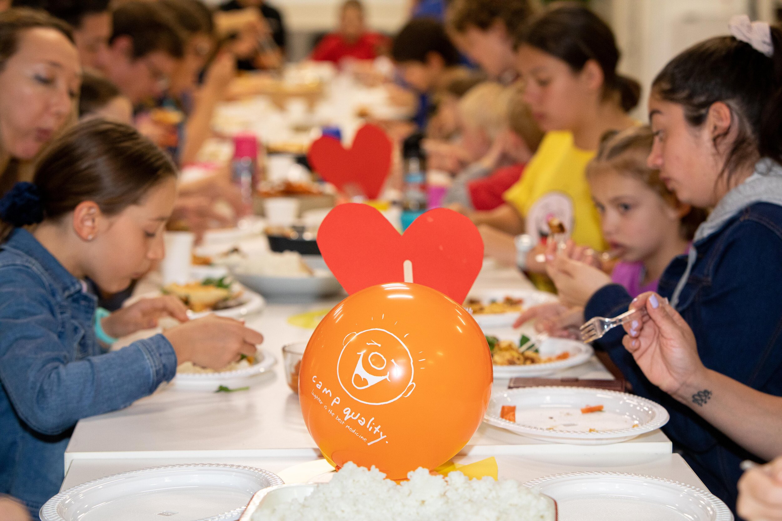 children eating at a table with party decorations