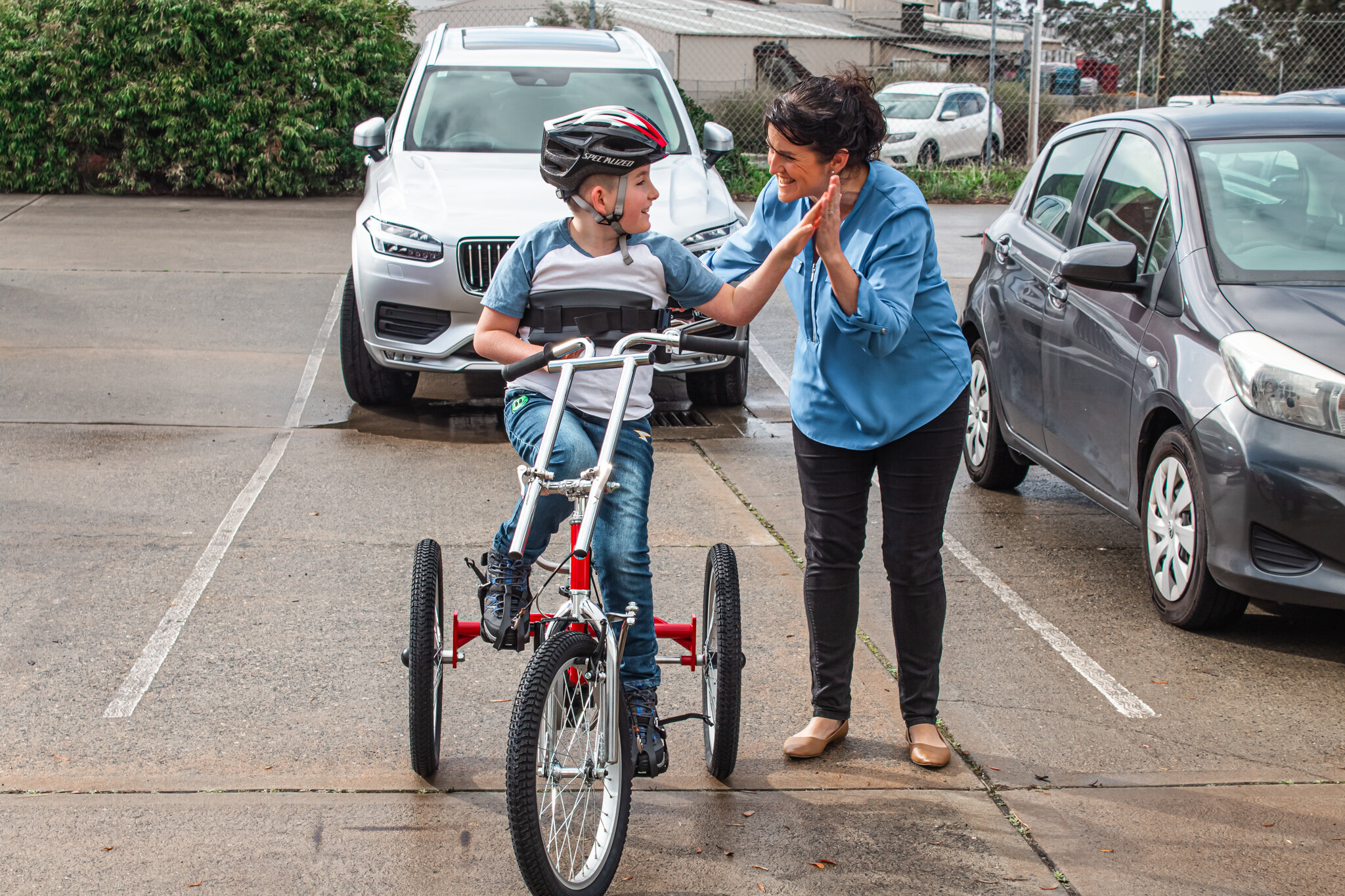 child riding modified trike for children with disabilities