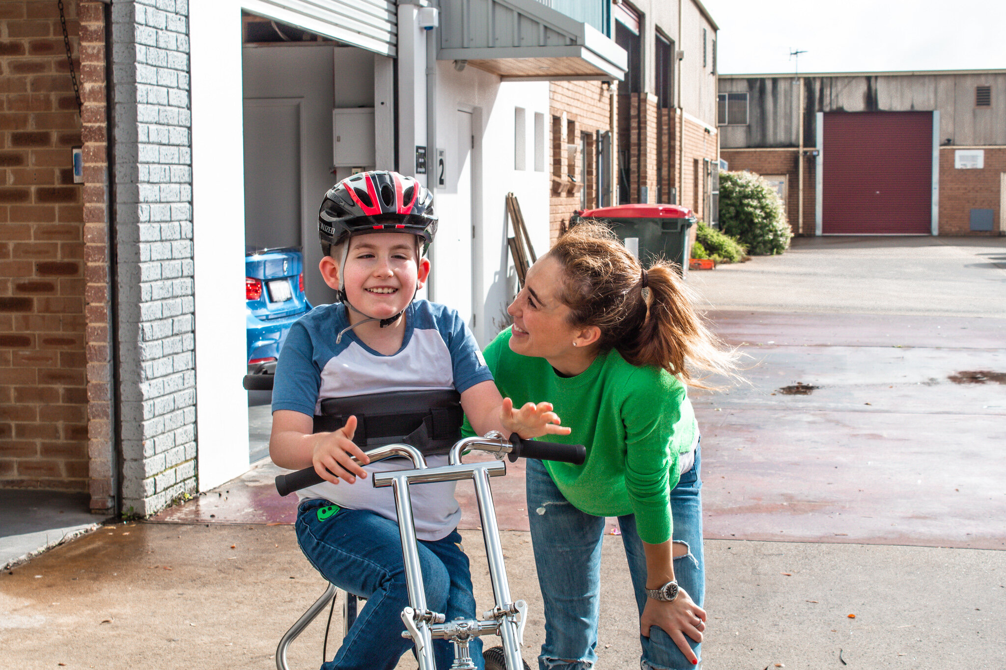 child riding modified trike for children with disabilities